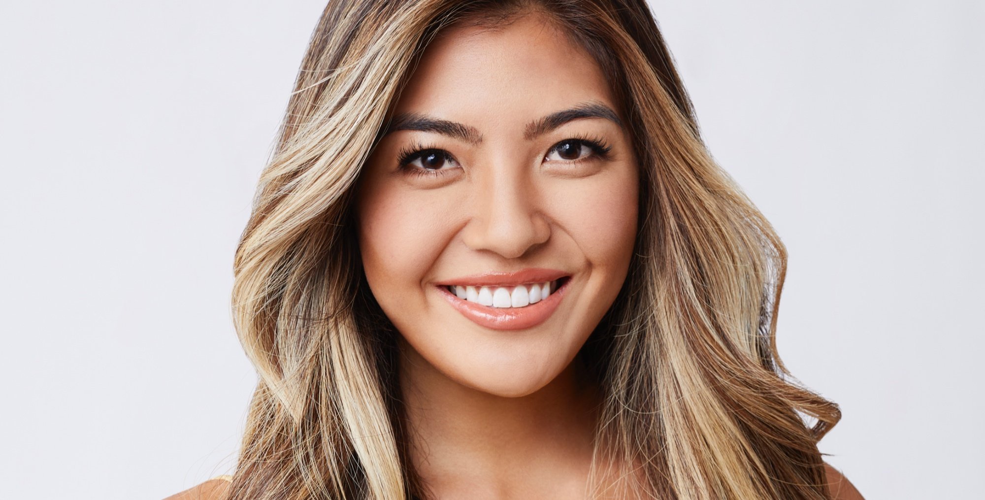 Ency Abedin for 'The Bachelor' 2022 Season 26 smiling with blonde hair.