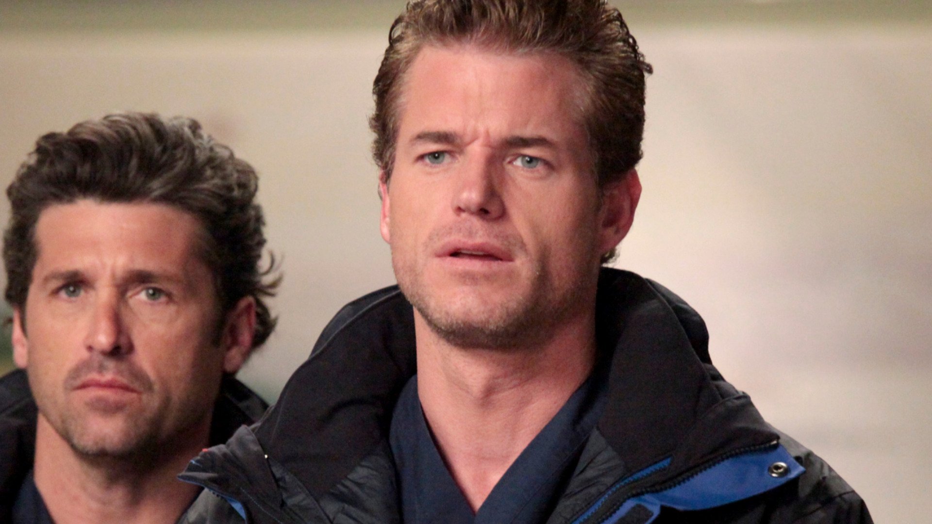 Eric Dane as Mark Sloan looking shocked in ‘Grey’s Anatomy’ with Patrick Dempsey as Derek Shepherd in the background