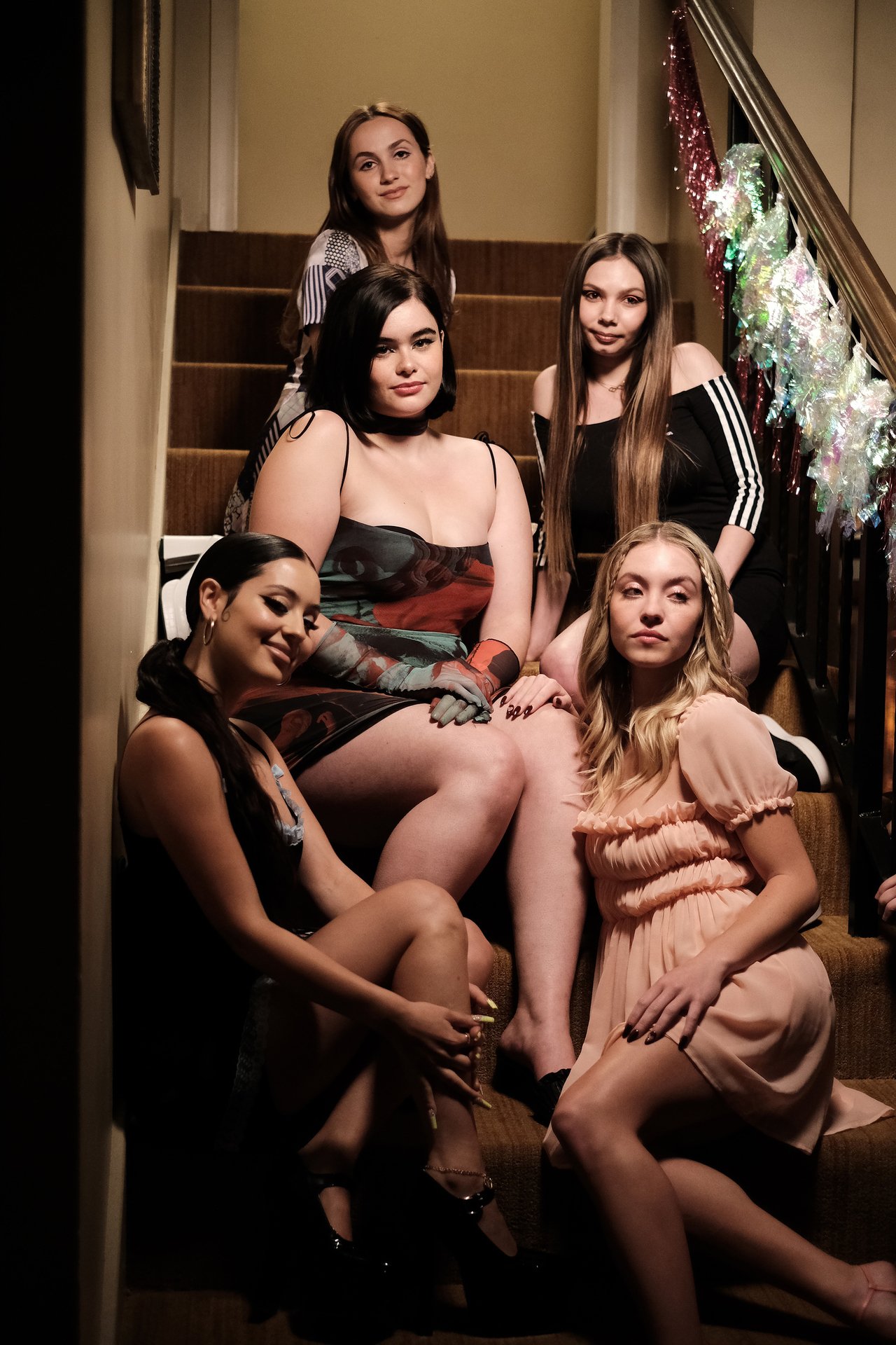 Cassie and Maddy sitting on a staircase posing for a photo in front of three of their friends in 'Euphoria' Season 2 Episode 4