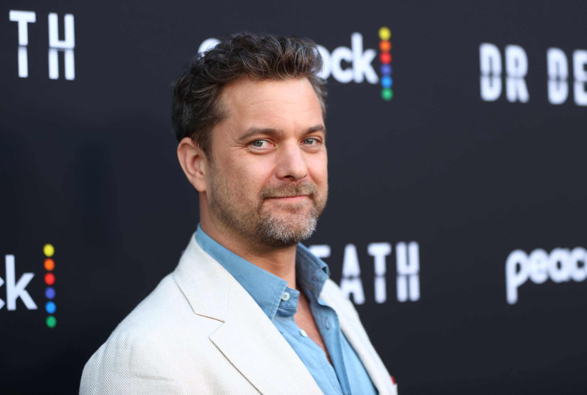 'Fatal Attraction' series star Joshua Jackson in a white blazer over a blue button down shirt.