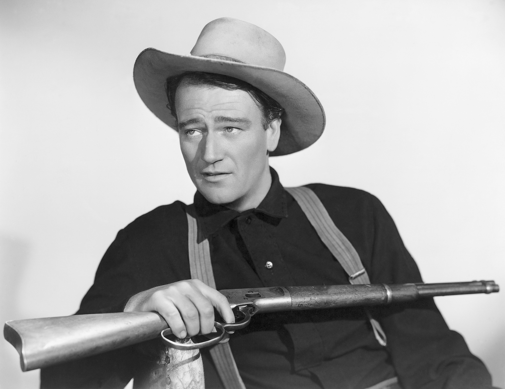 'Four Sons' John Wayne holding a rifle for 'Shepherd of the Hills'