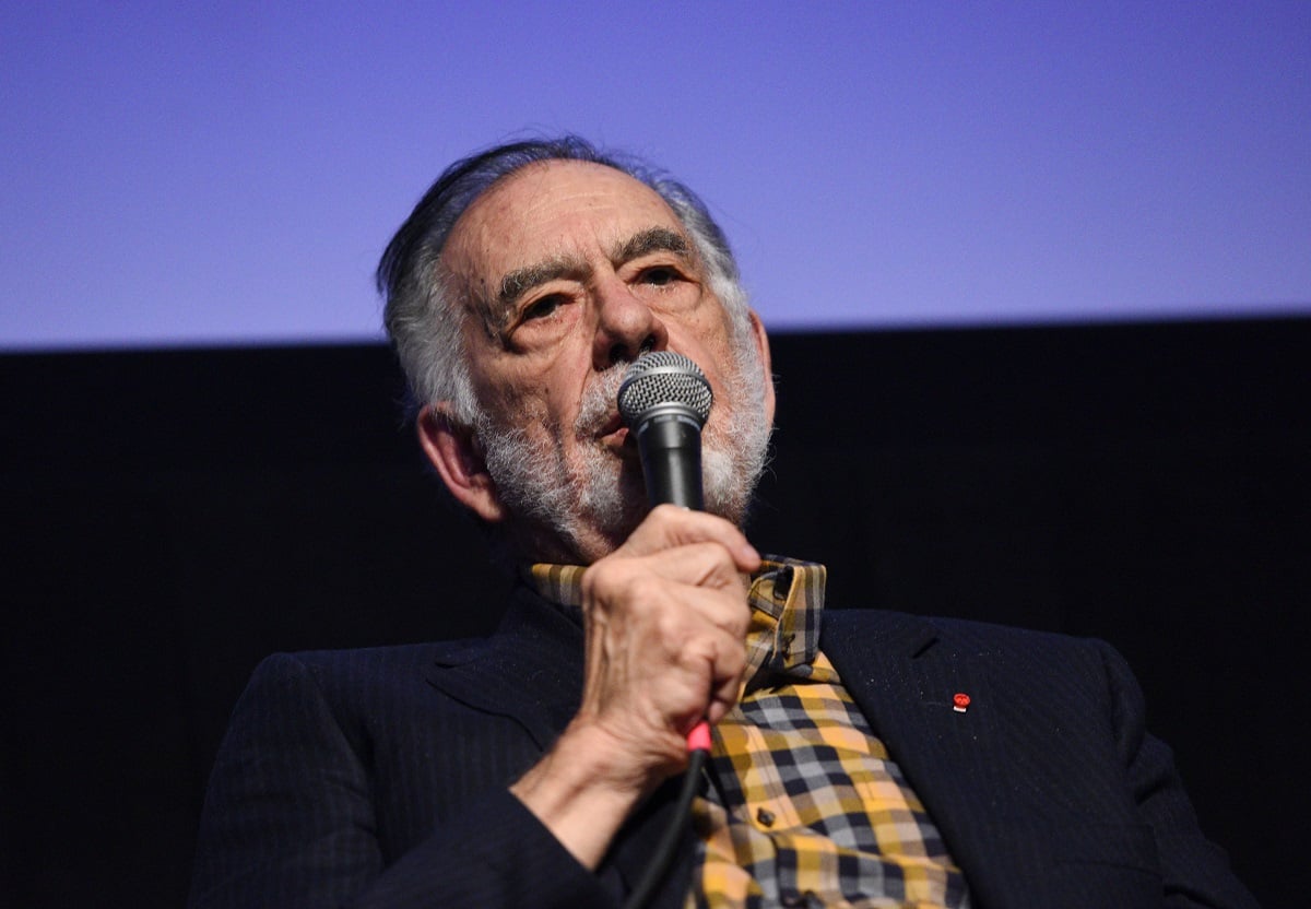 Francis Ford Coppola holding a microphone.