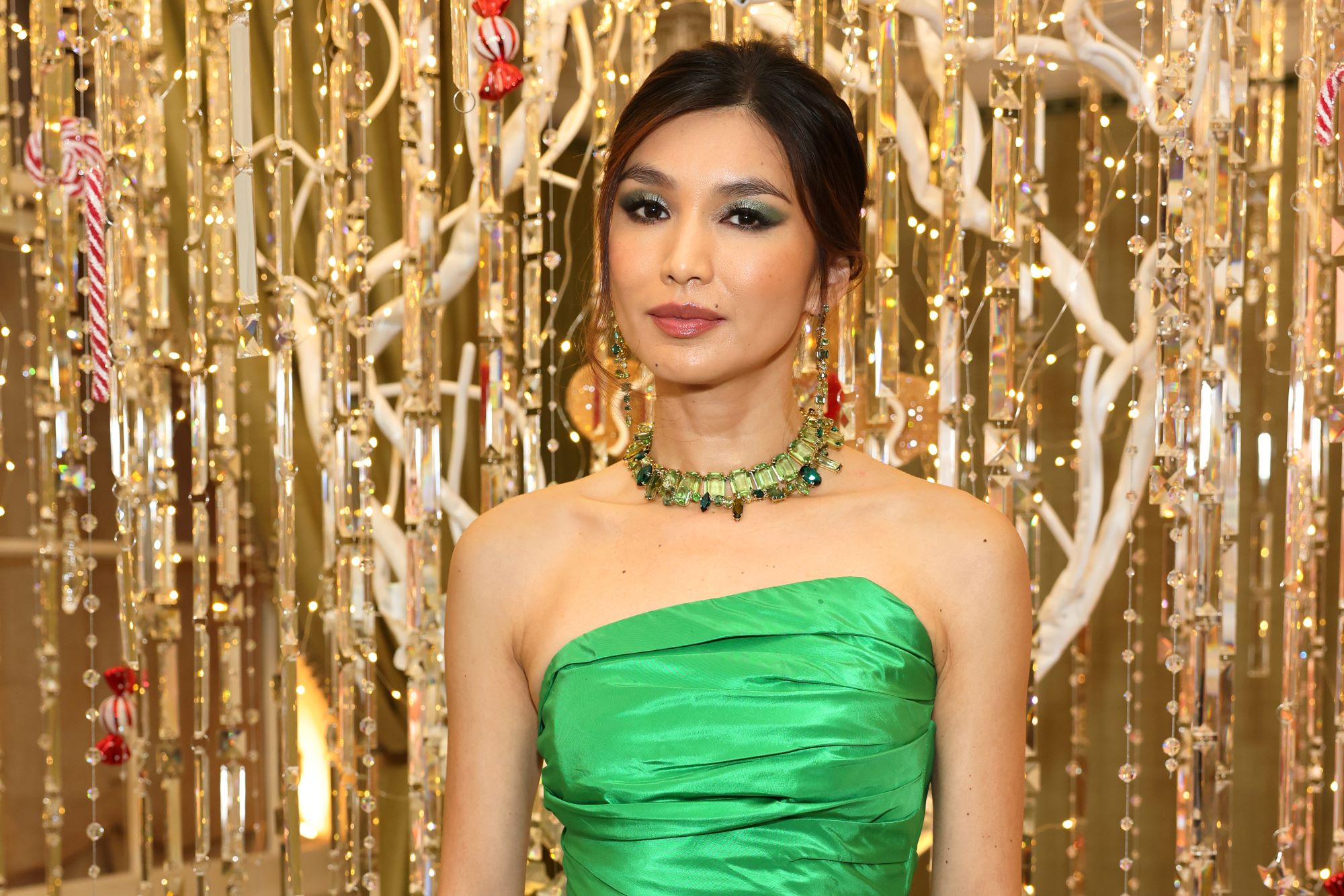 'Eternals' star Gemma Chan wears a bright green strapless dress and a green necklace.