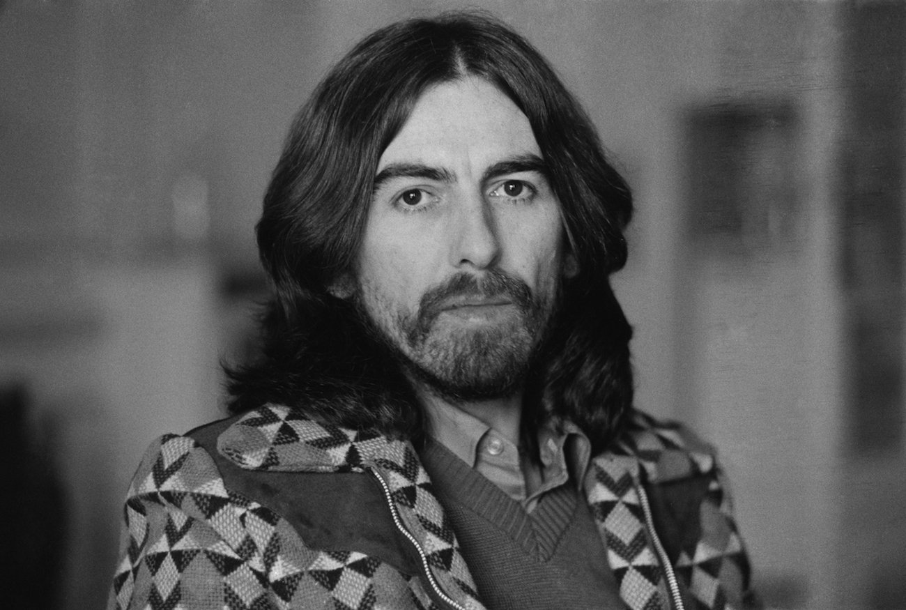 George Harrison in a jacket posing in Cannes, France, 1976.