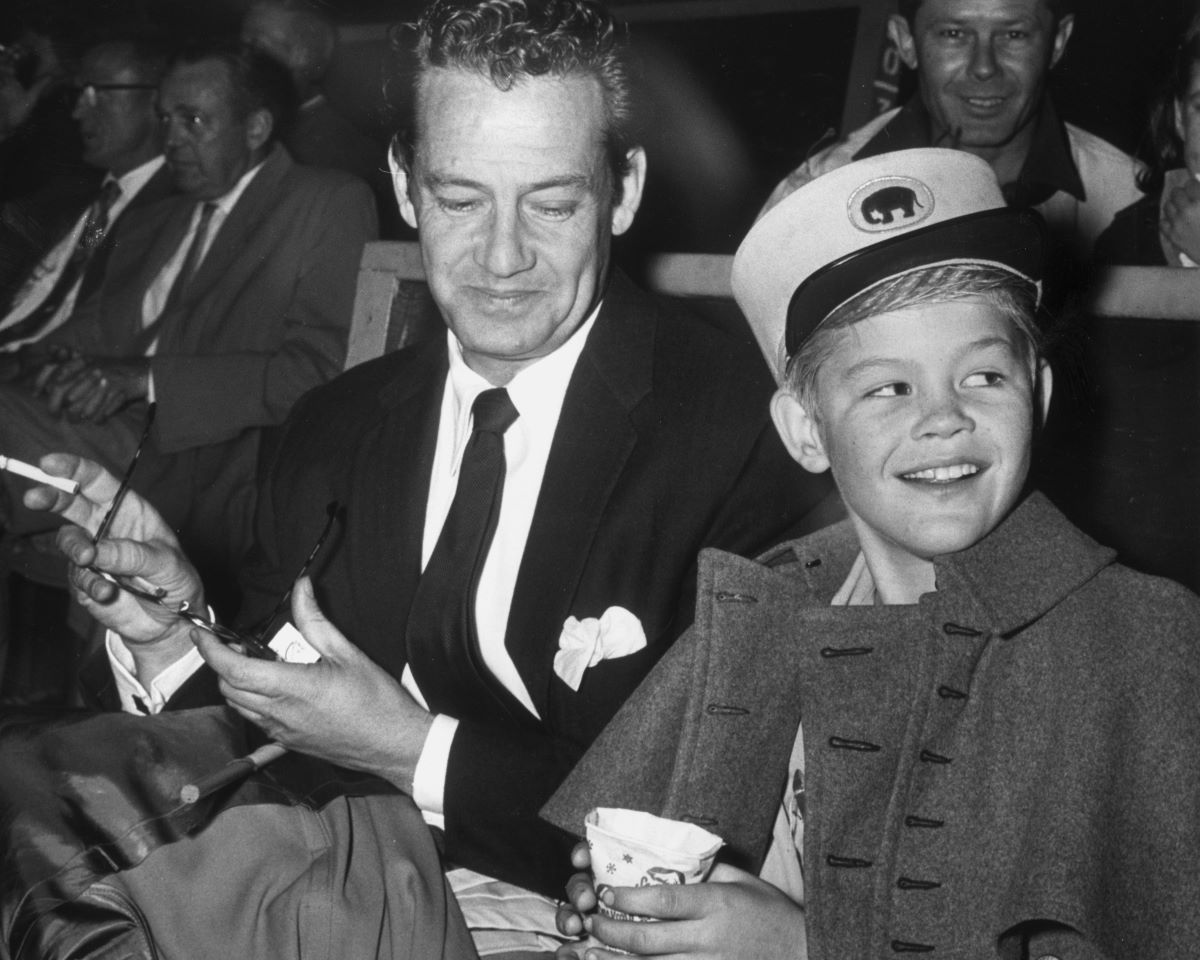 George Dolenz smokes a cigarette while Micky Dolenz holds a sno-cone, c. 1956