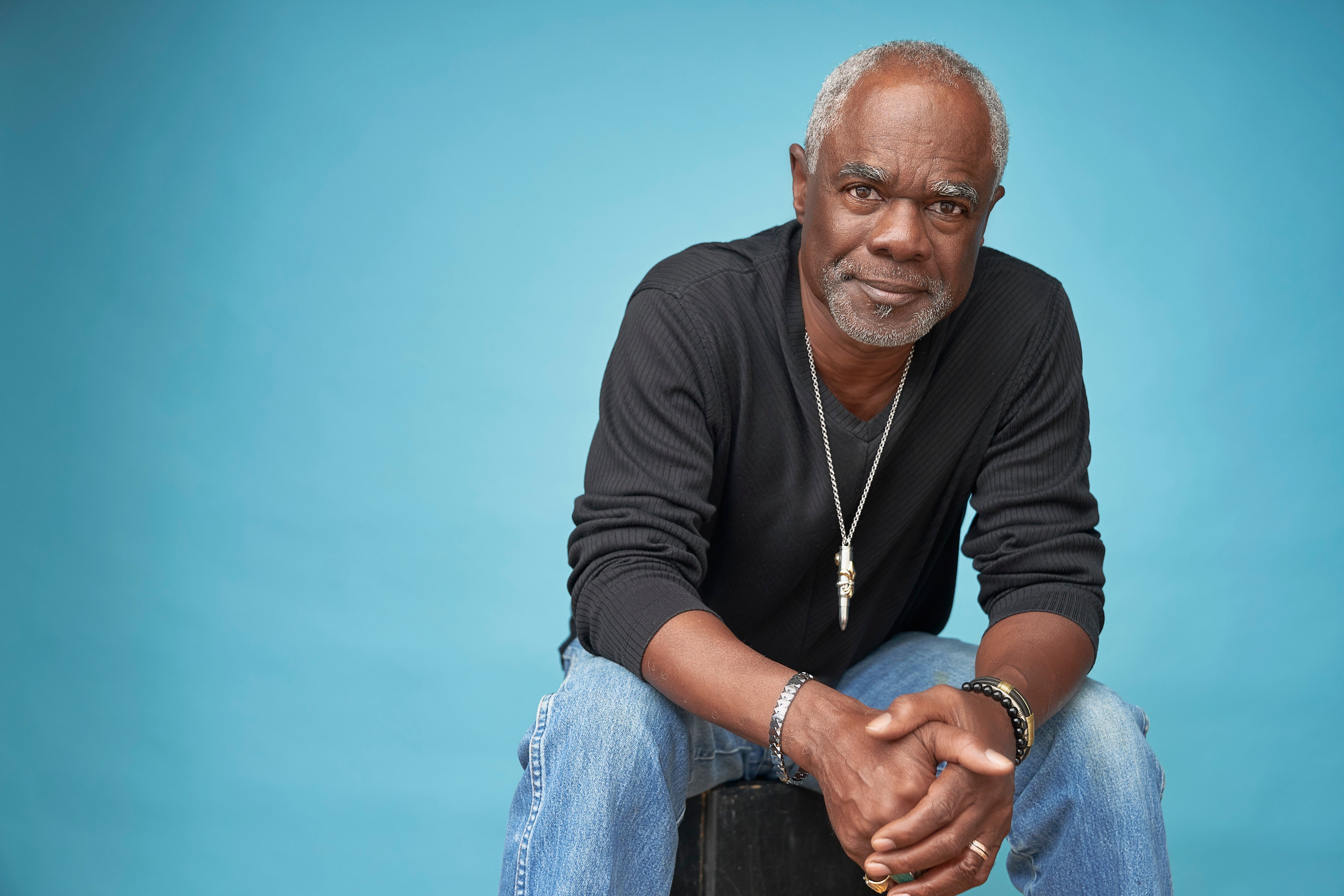 Glynn Turman looking into the camera with his hands together