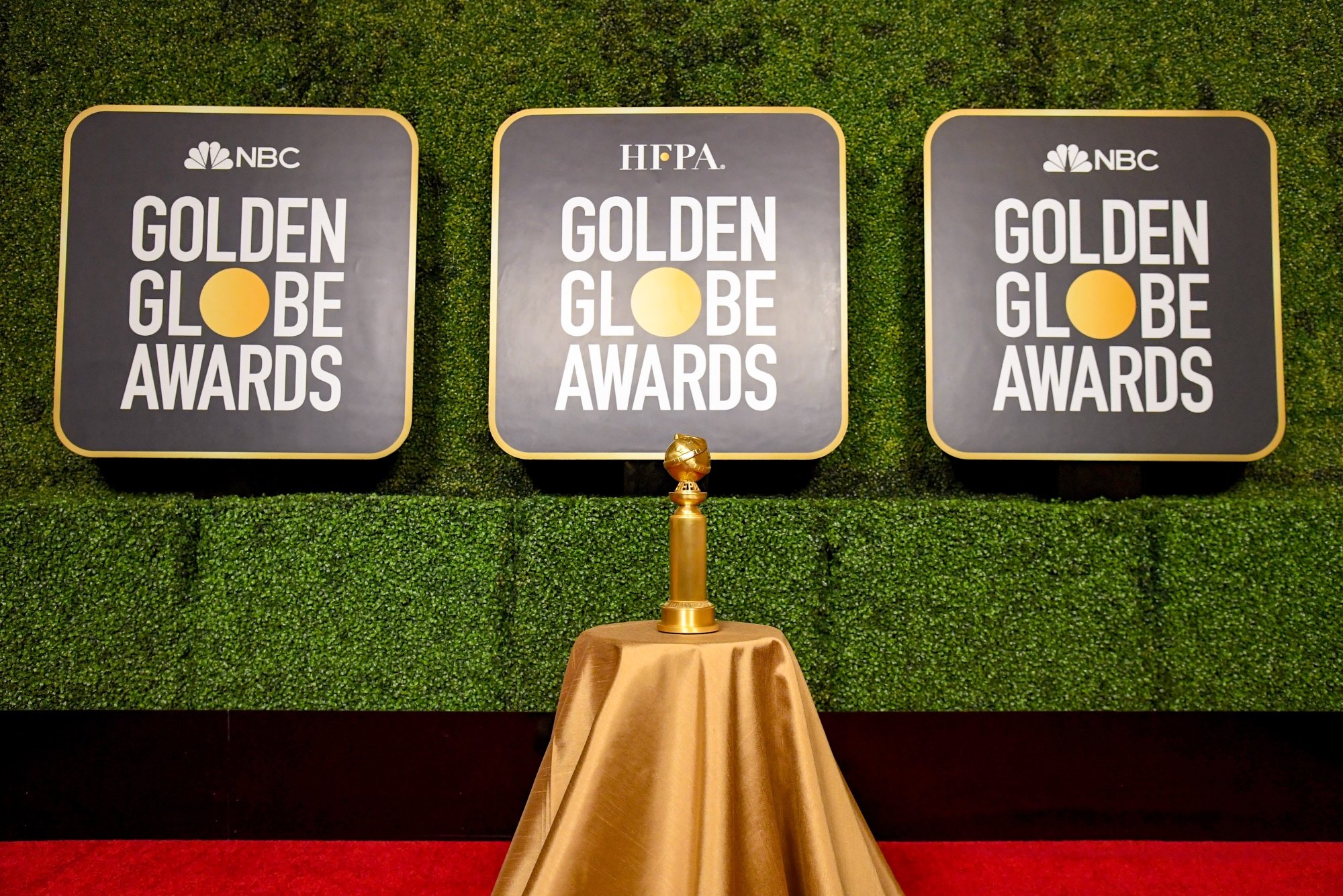 Golden Globes award on table with golden cloth on the red carpet in article about voting process