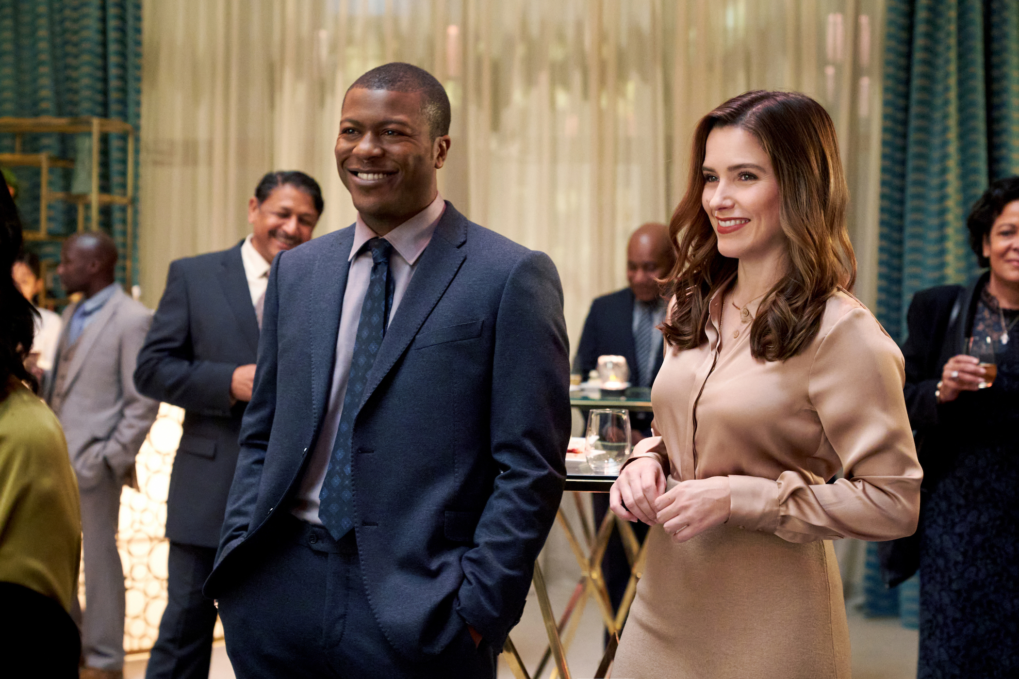 Sam Griffith and Malcolm Kingsley standing next to each other at an event and smiling in 'Good Sam'