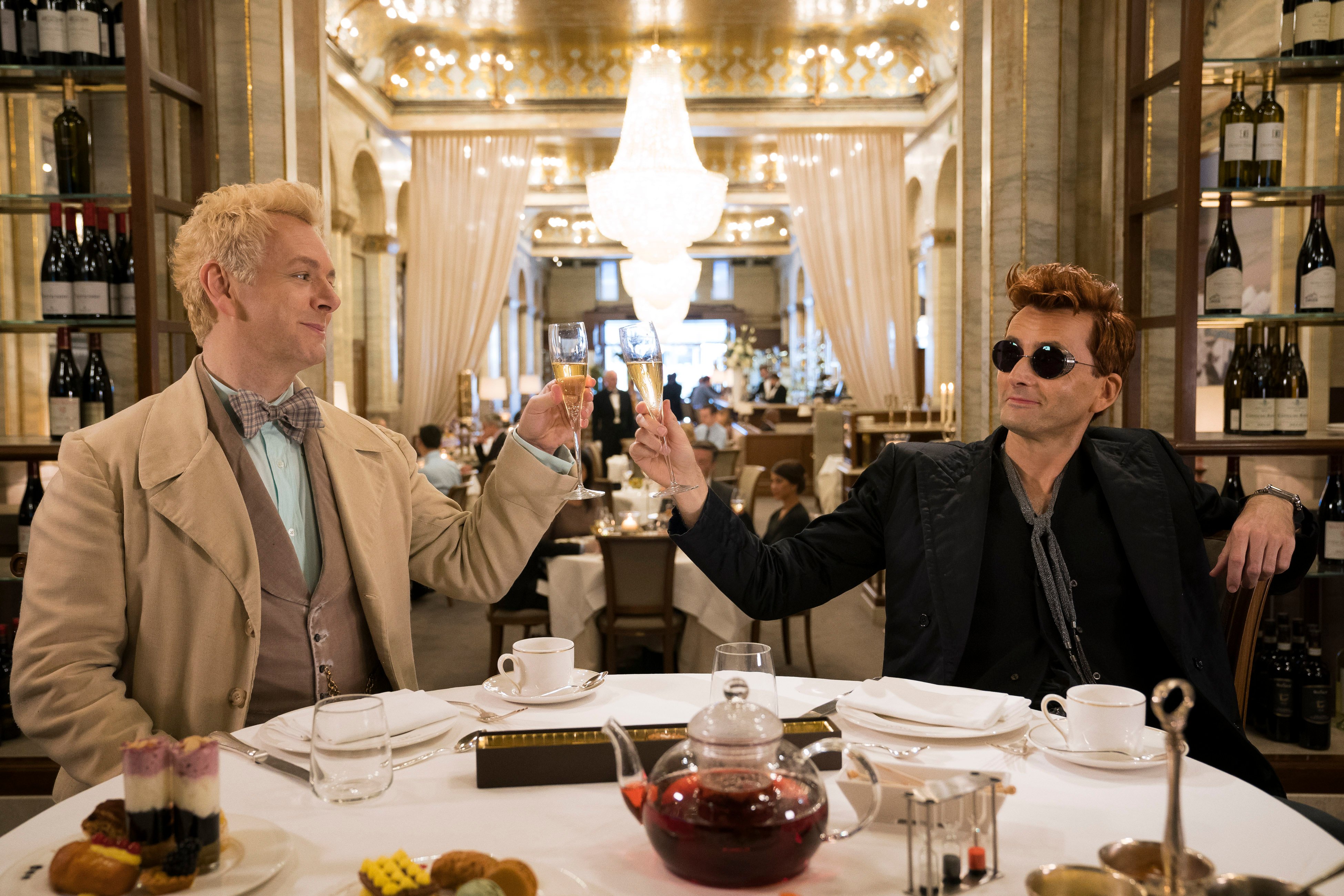 Michael Sheen in a white suit and David Tennant in a black suit in 'Good Omens'