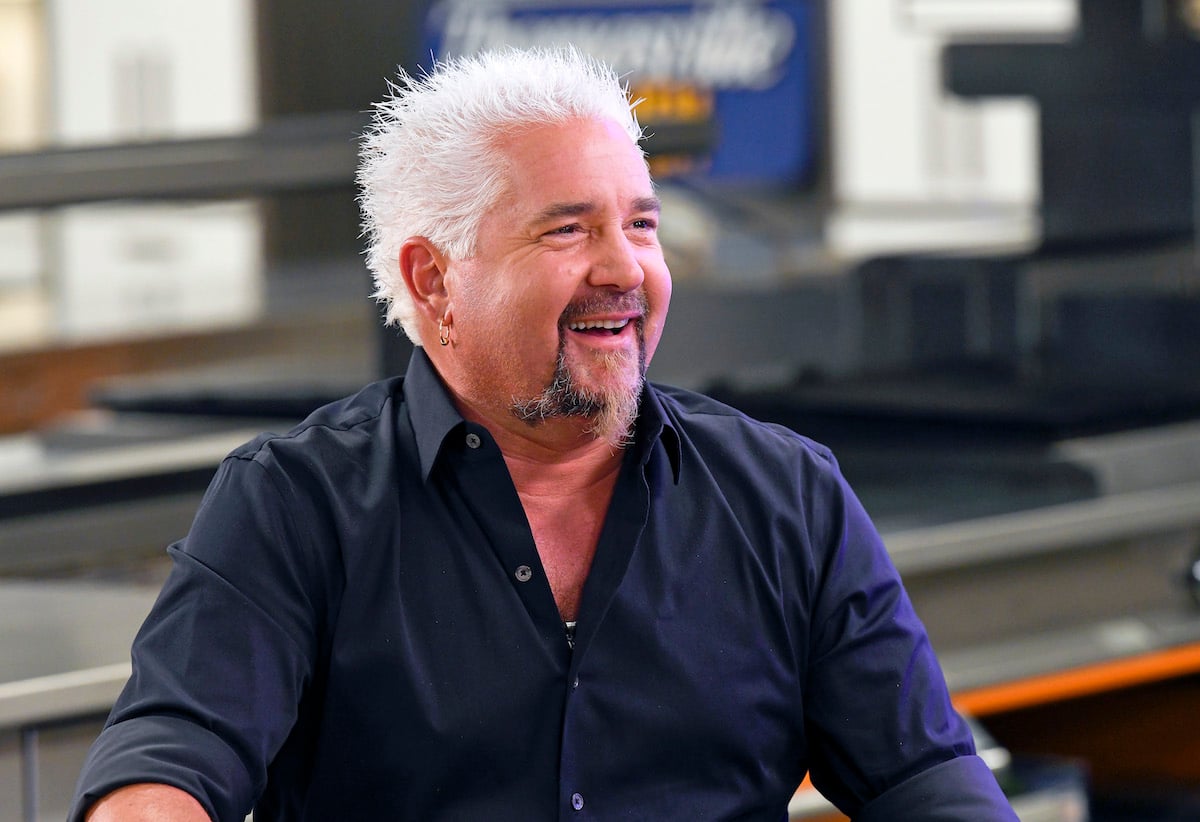 Chef Guy Fieri smiles while filming his show