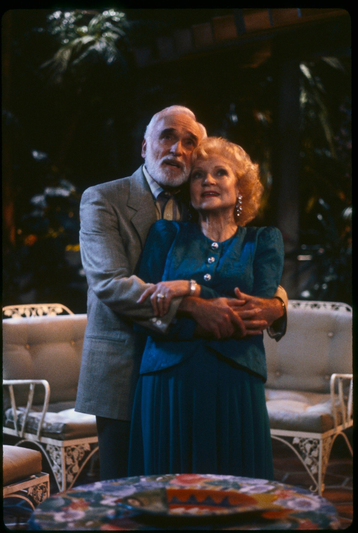 'The Golden Girls' actor Harold Gould hugs Betty White on patio set of the sitcom.