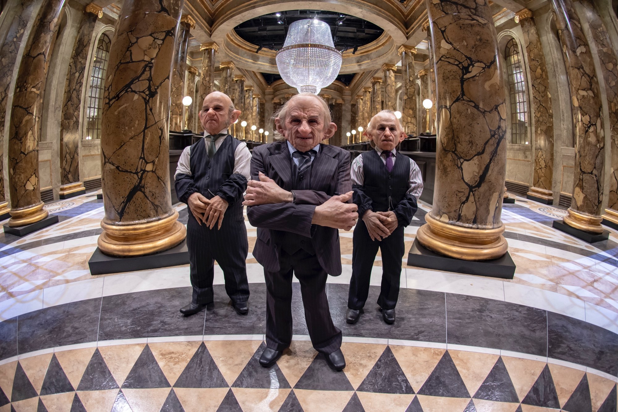 'Harry Potter' goblins in the Gringotts Wizarding Bank wearing suits for article about Jon Stewart 