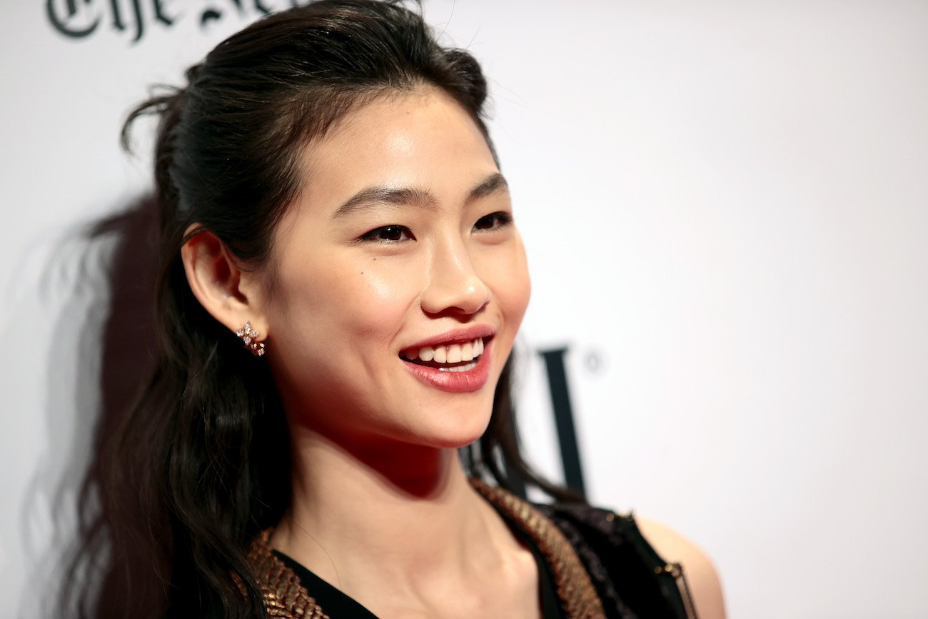 HoYeon Jung smiling in front of a white background