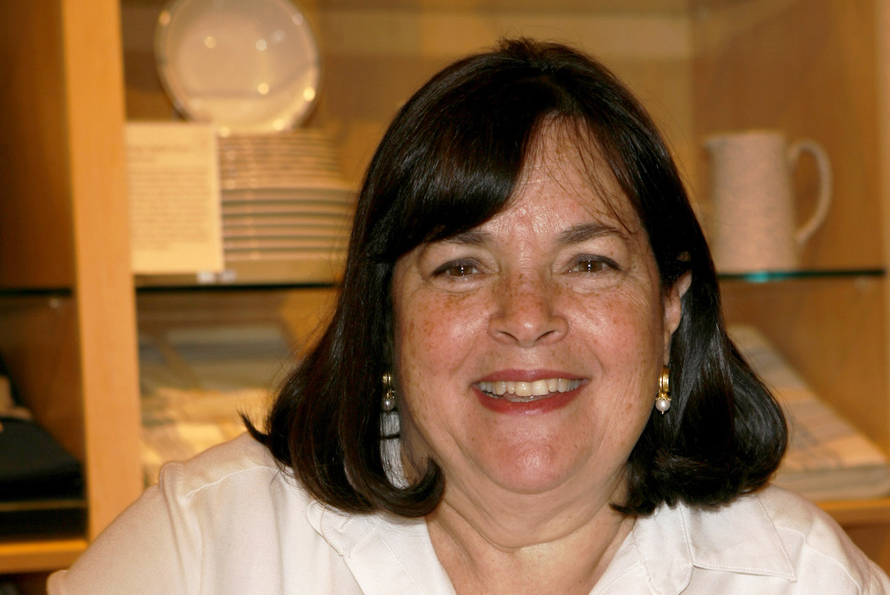 Ina Garten smiles wearing a white shirt at a Barefoot Contessa cookbook signing