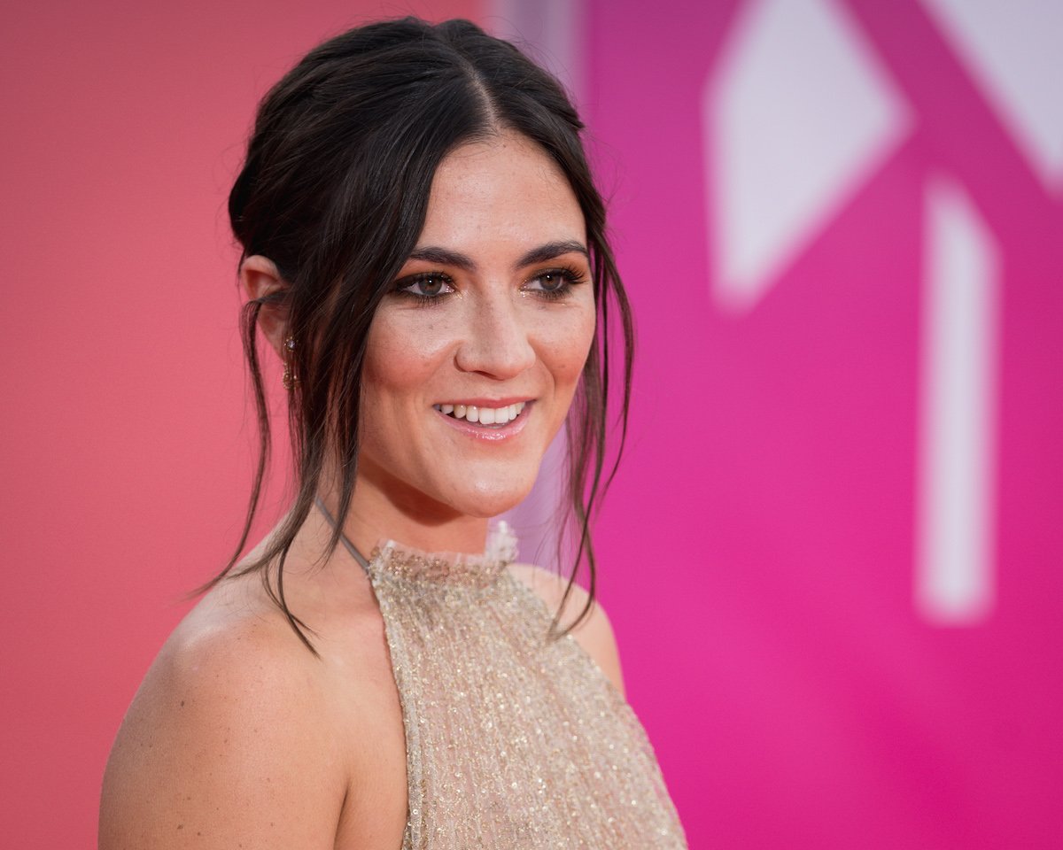 Isabelle Fuhrman wears a dress and smiles on the red carpet