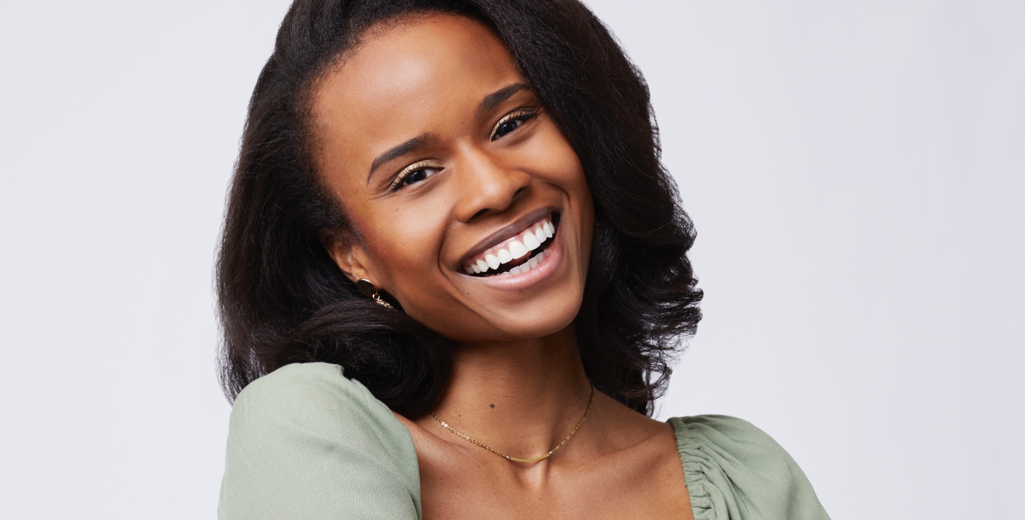 Ivana Noble for 'The Bachelor' Season 2 wearing green blouse and smiling.