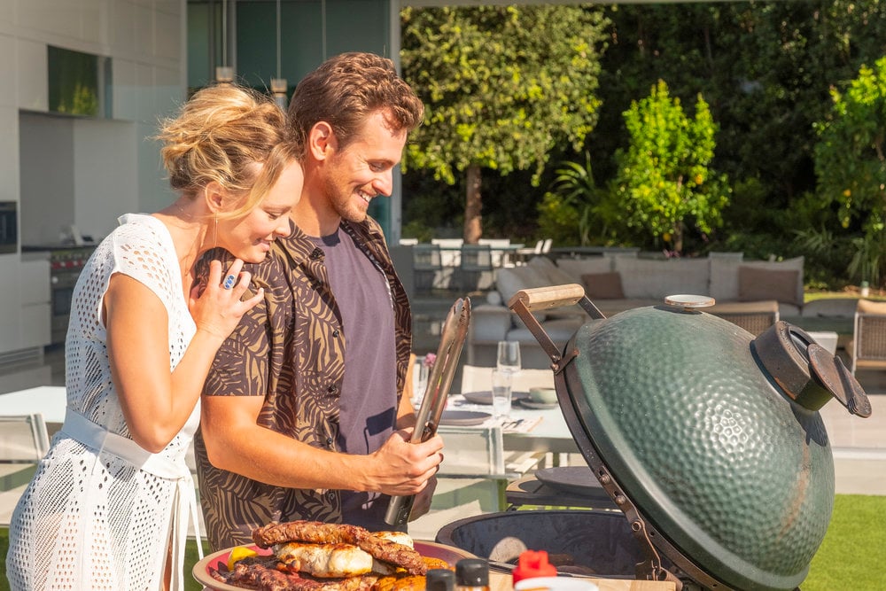 Auden Thornton as Lucy and Blake Stadnik as Jack Damon cook on the Big Green Egg in ‘This Is Us’ Season 6 Episode 3