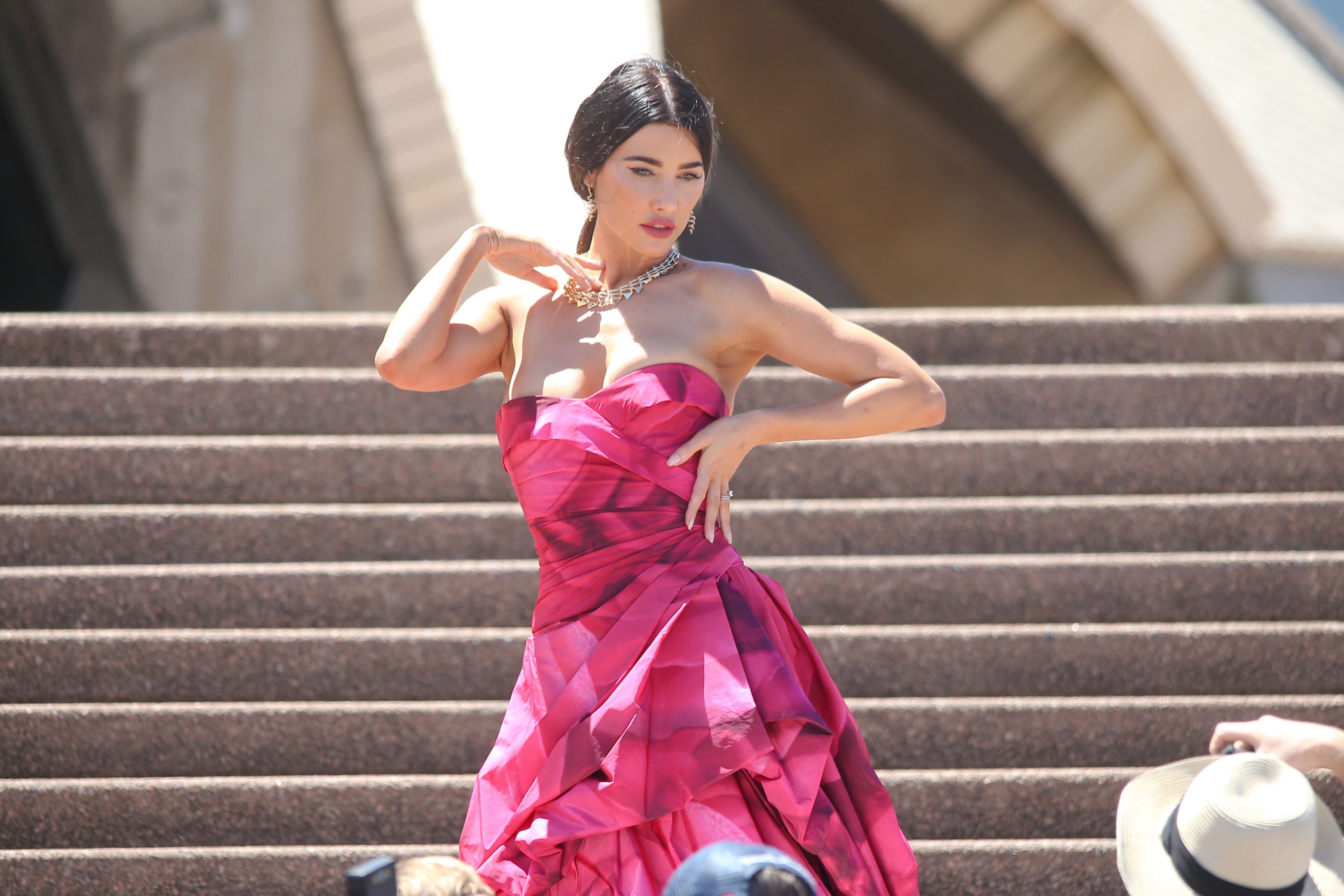 'The Bold and the Beautiful' actor Jacqueline MacInnes Wood wearing a pink dress and posing in front of the Sydney Opera House.