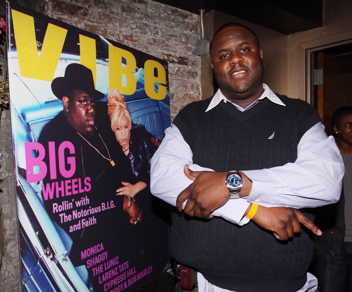 Jamal "Gravy" Woolard poses next to iconic Biggie magazine cover