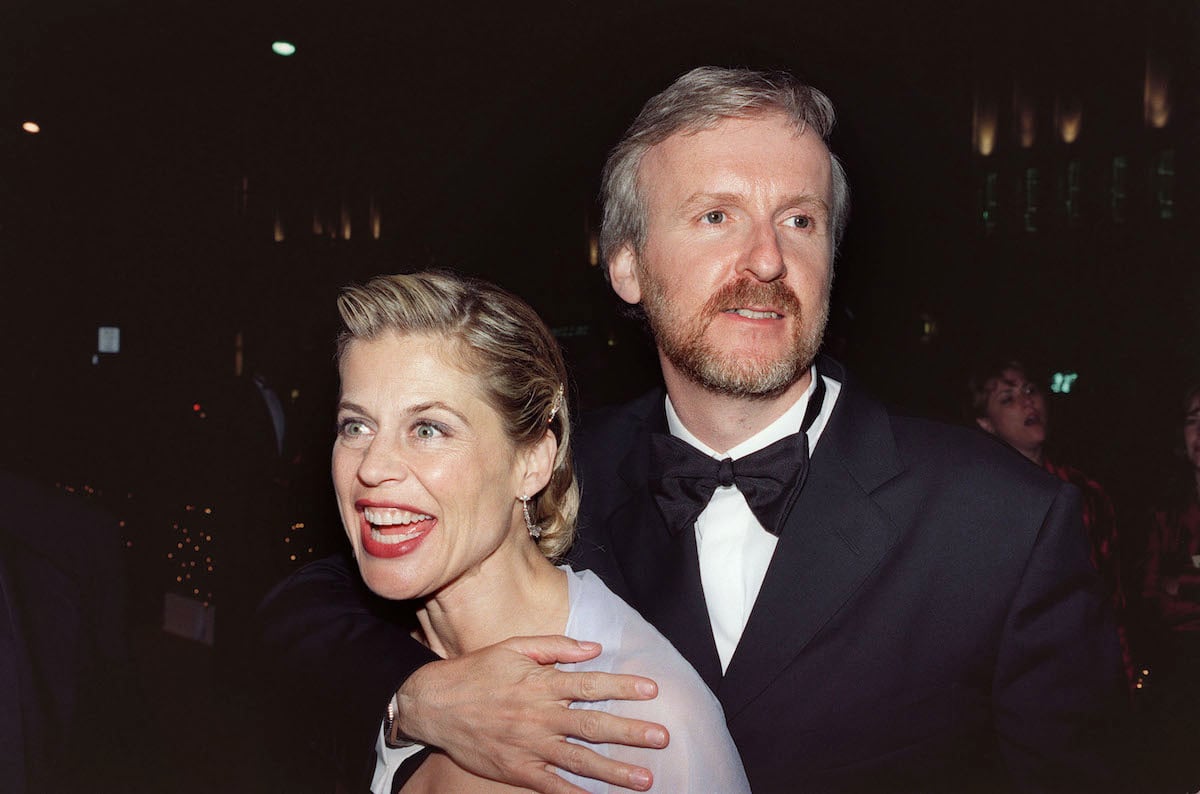 Director James Cameron and wife, actress Linda Hamilton, hold three Oscar awards as they arrive for the Governors Ball following the 1998 Academy Awards