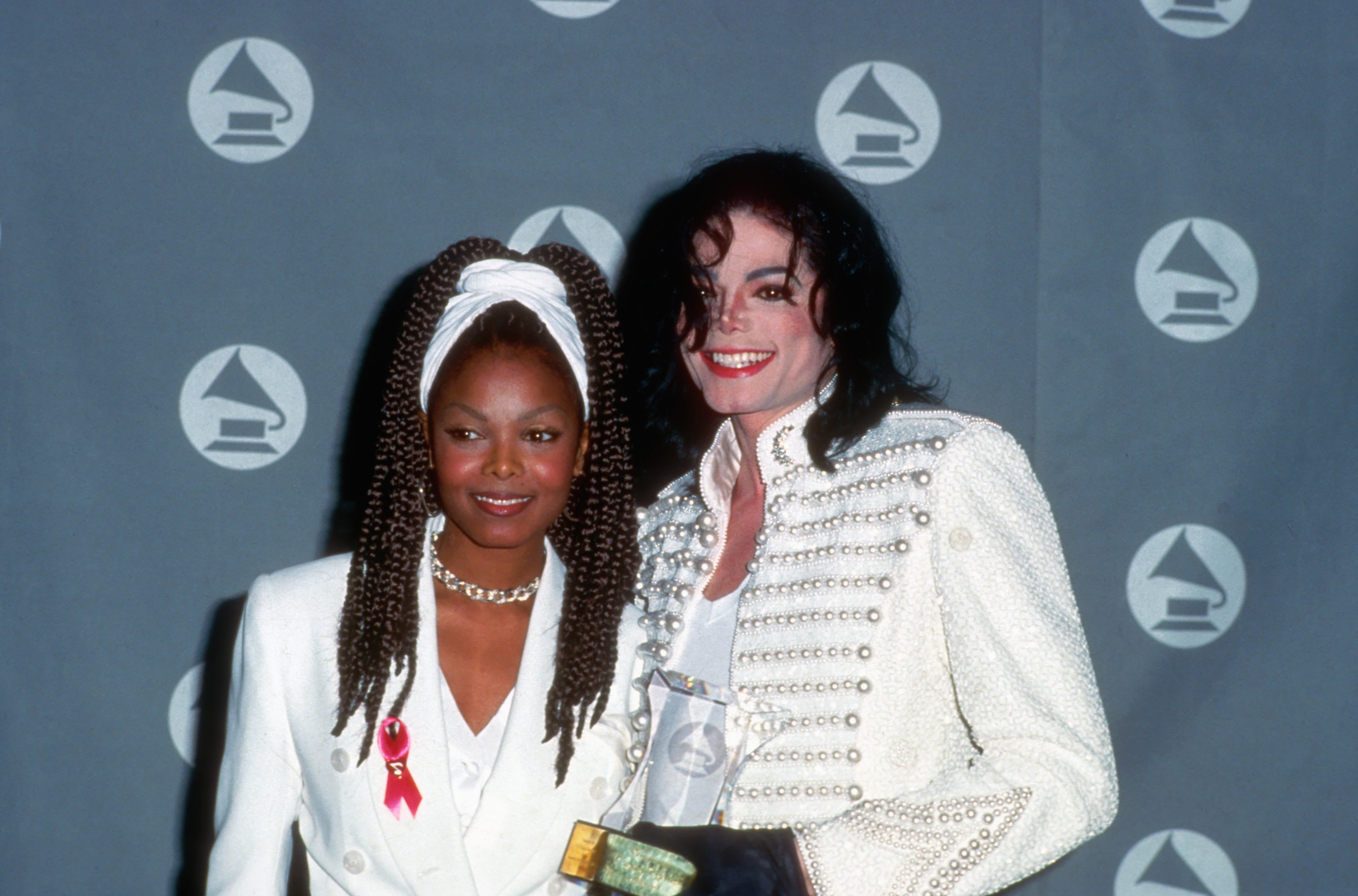 Janet Jackson and Michael Jackson pose for a photo backstage at the GRAMMY Awards in 1993