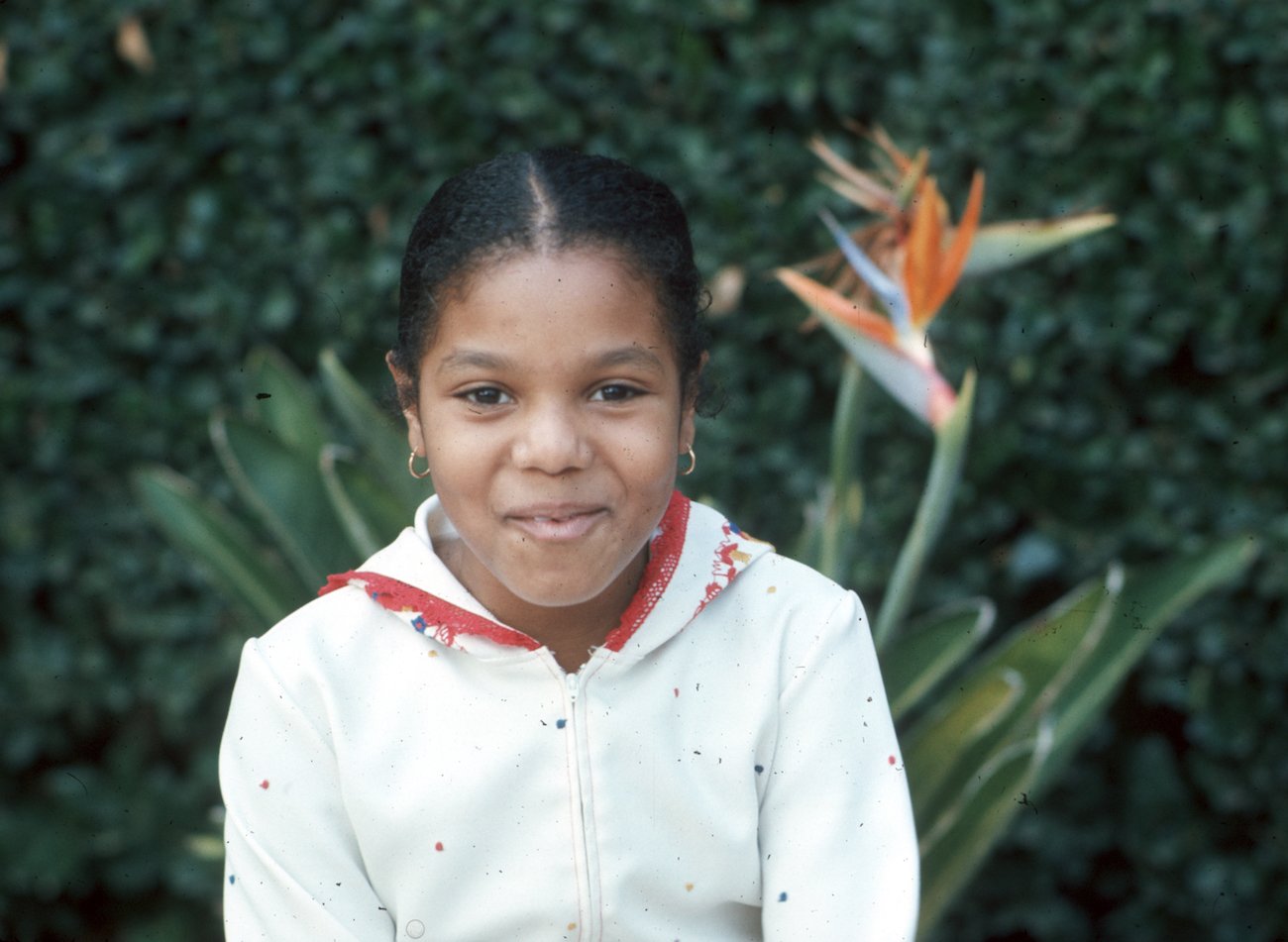 Janet Jackson posing for a portrait in a white jacket at the Jackson family home in 1977.