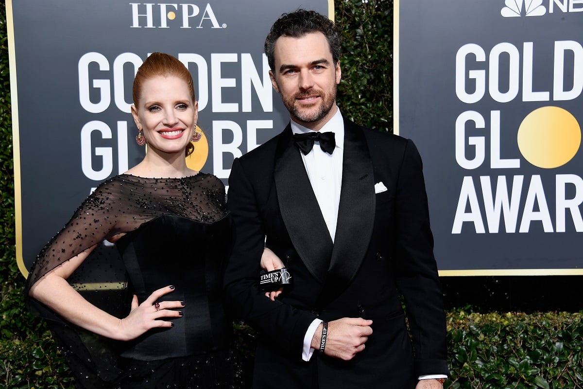 Jessica Chastain and Gian Luca Passi de Preposulo smile on the red carpet at the Golden Globe Awards 