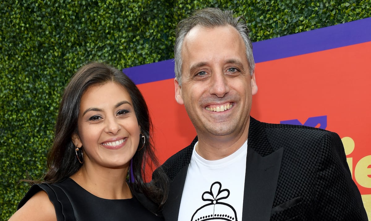 Joe Gatto and Bessy Gatto wear black outfits on the red carpet at an event