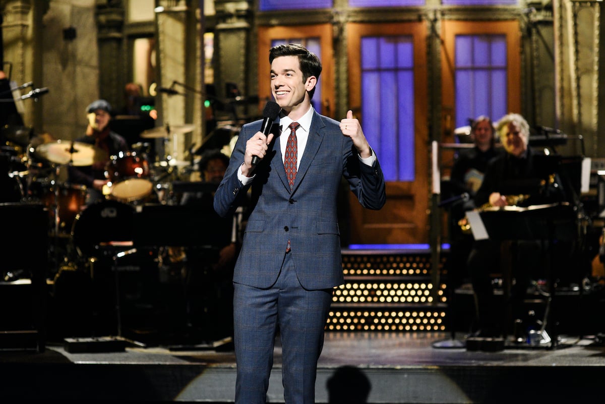 John Mulaney smiling on the 'Saturday Night Live' stage