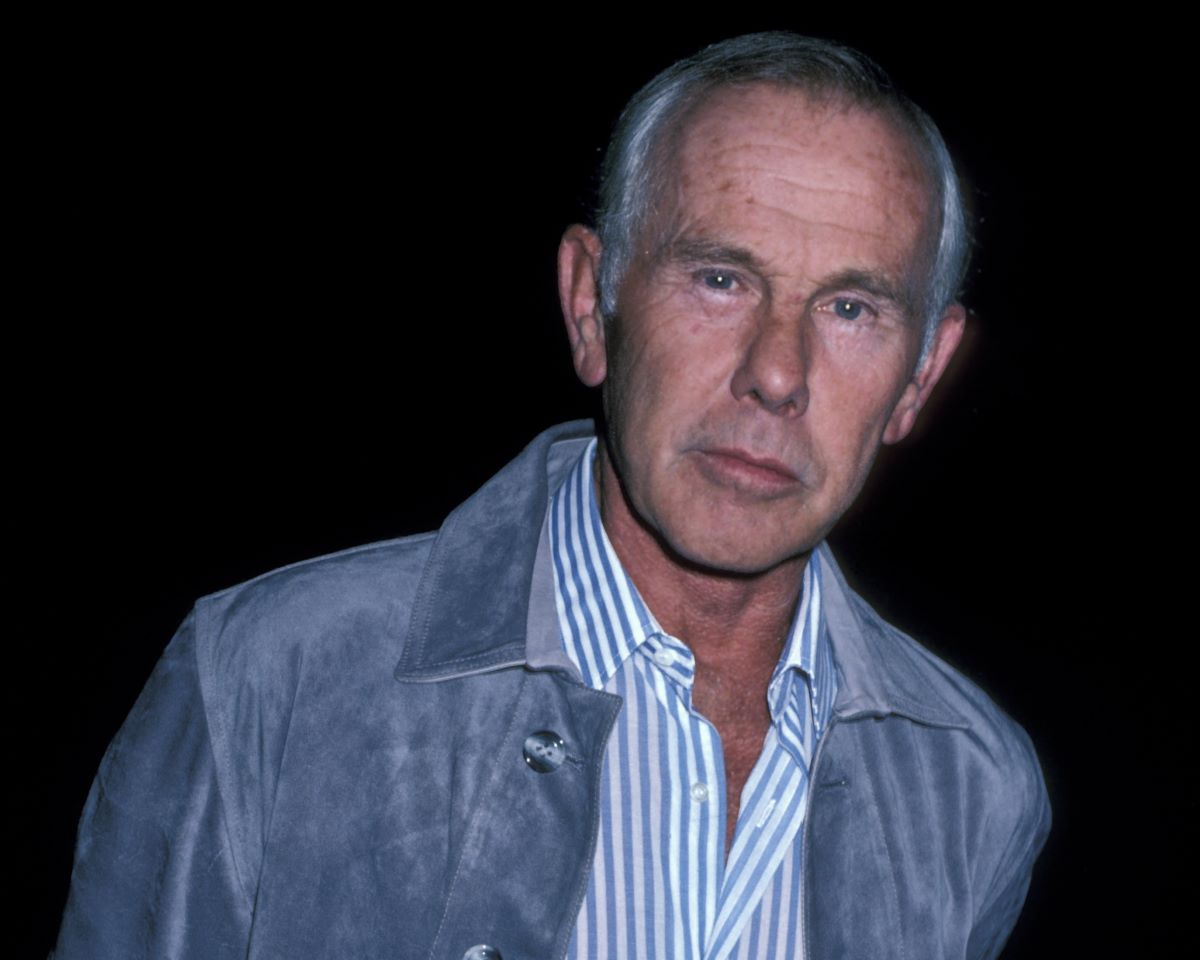 Johnny Carson in a striped button-down shirt and blue jacket in 1986.