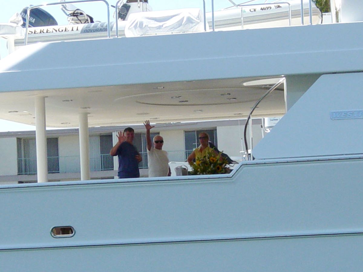 Johnny Carson and others waving aboard his yacht, the Serengeti