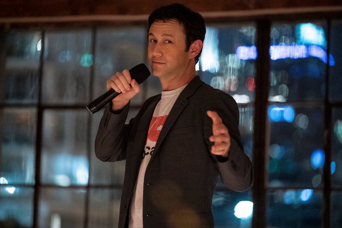 Joseph Gordon-Levitt as Travis Kalanick, holding a microphone and wearing a blazer, in 'Super Pumped'