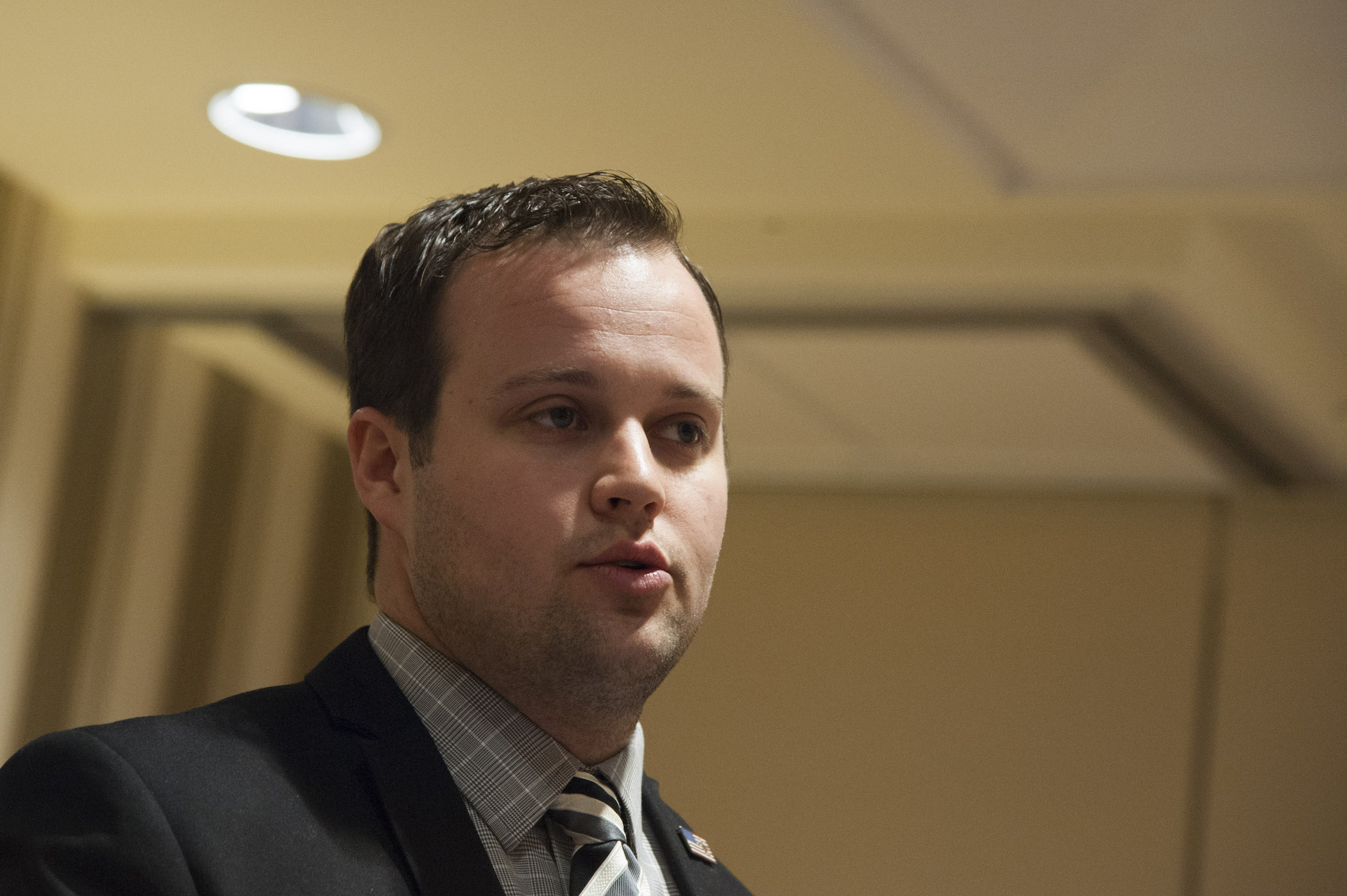 A close-up of Josh Duggar of the Duggar family's face while he's speaking at a conference