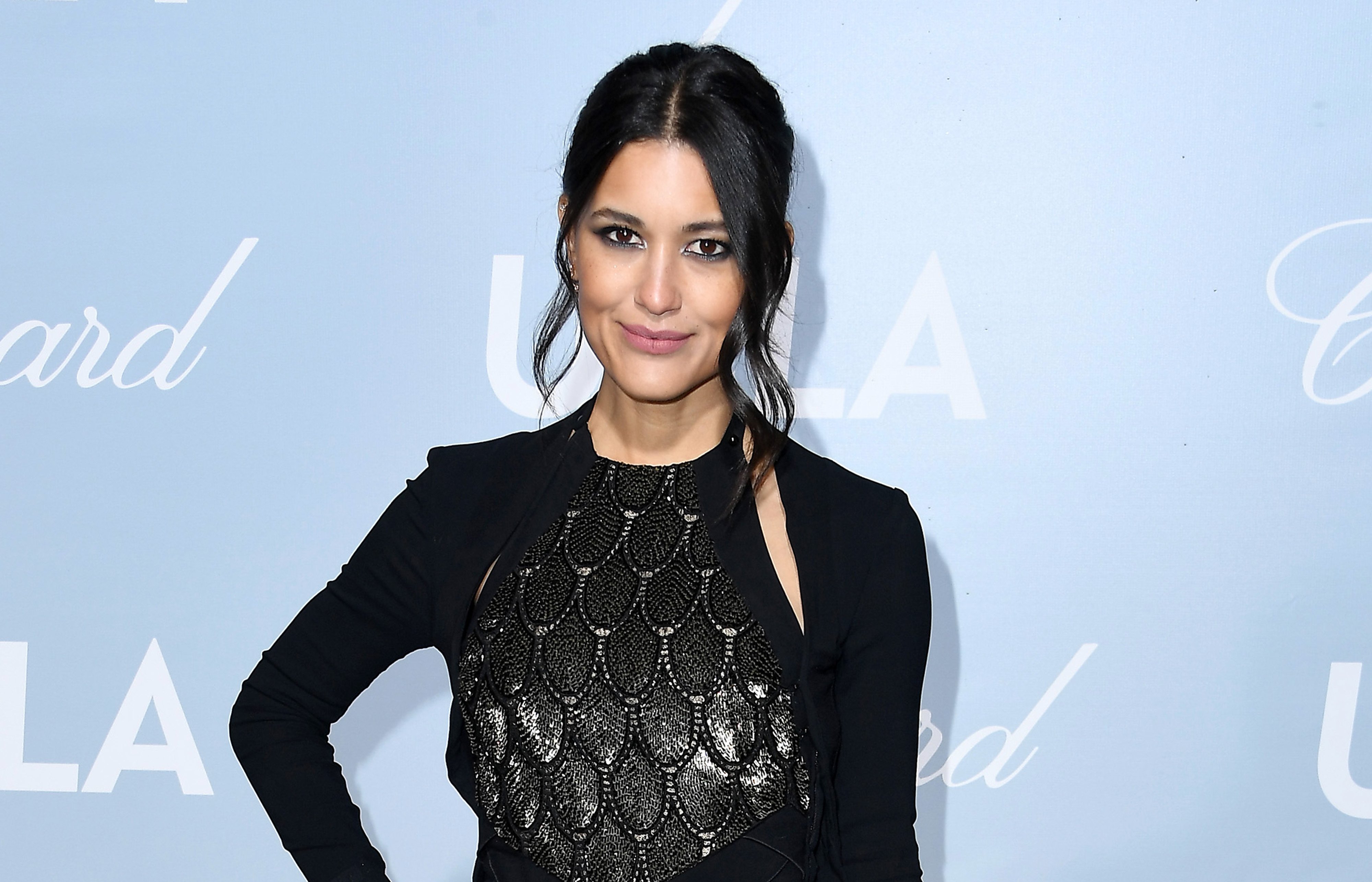 Dexter: New Blood star Julia Jones attends the 2019 Hollywood For Science Gala at Private Residence. Jones has her hair up and is wearing a black dress.