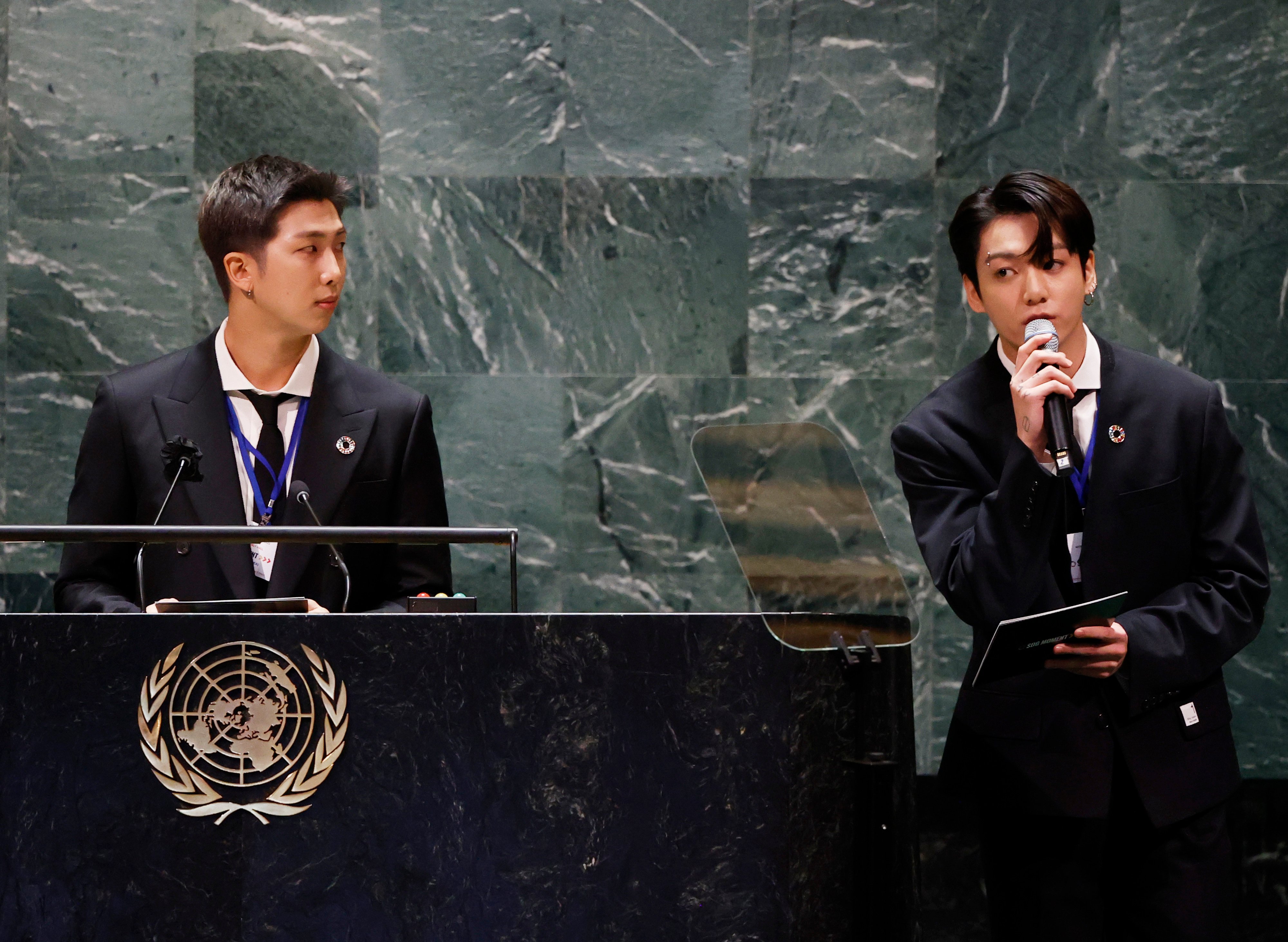RM listens as Jungkook of the boy band BTS speaks at the SDG Moment event