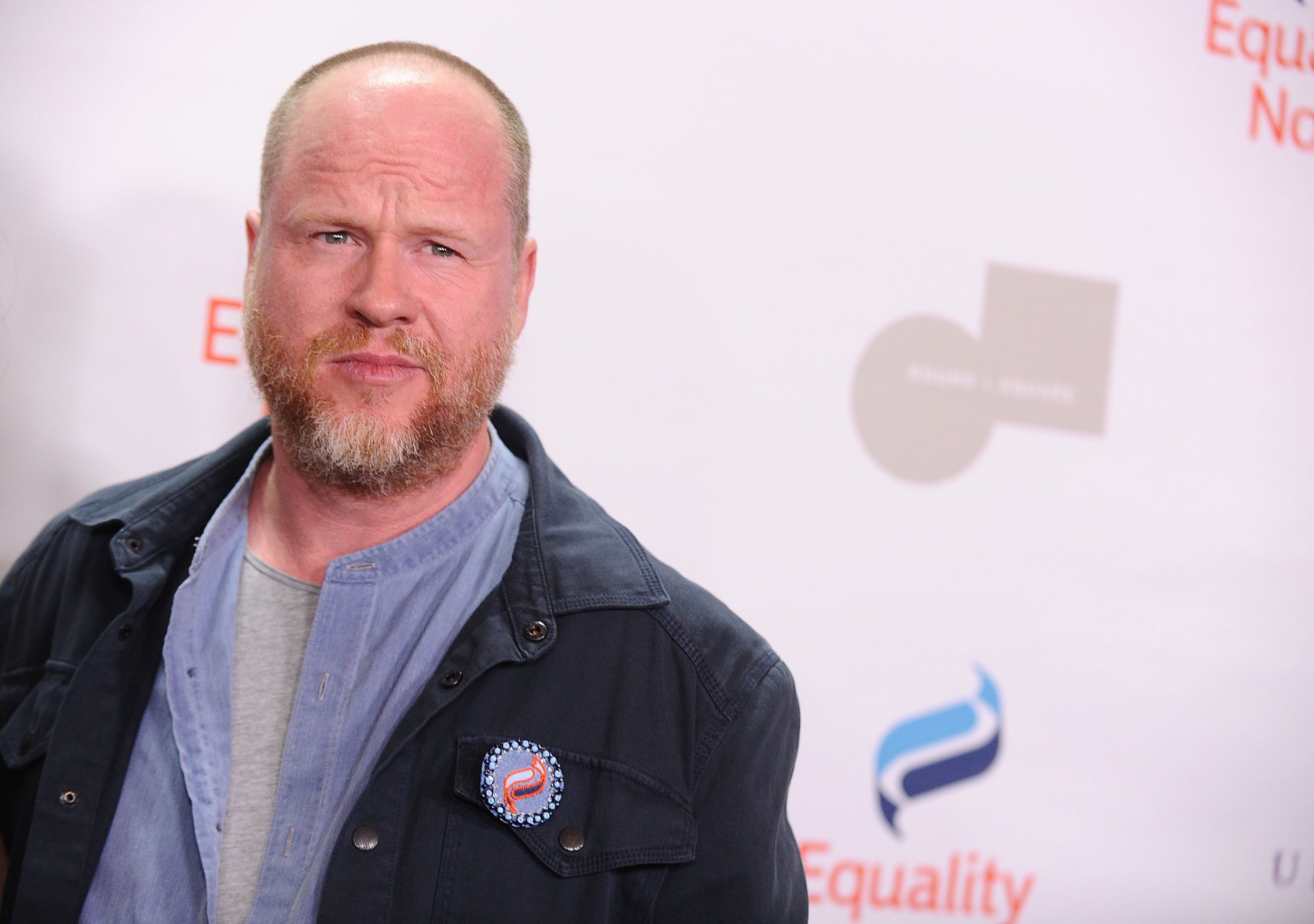 'Justice League' filmmaker Joss Whedon standing in front of step and repeat