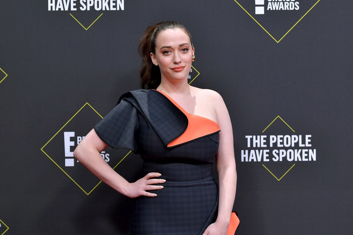 Kat Dennings smiling while wearing a dress.