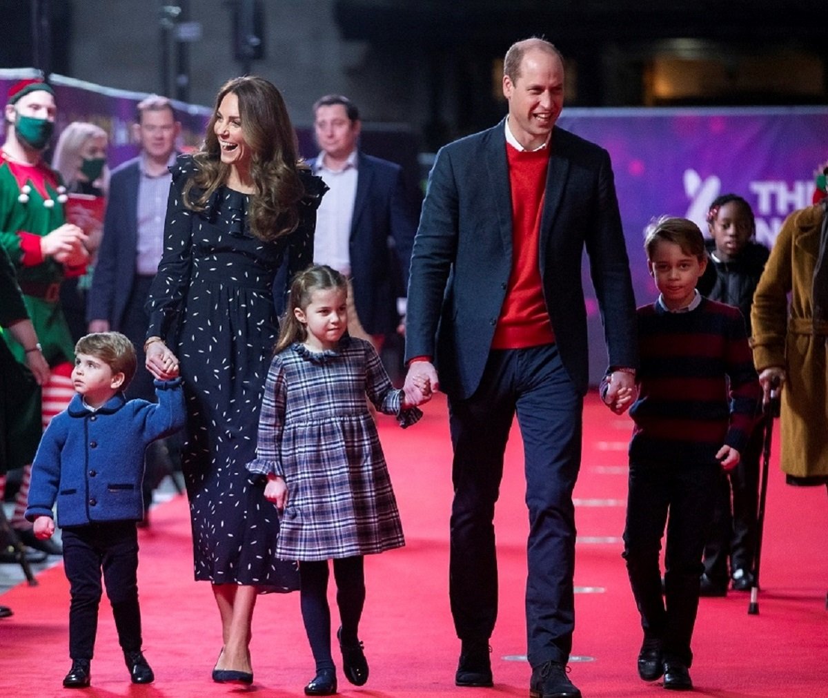 Kate Middleton and Prince William with their kids Prince Louis, Princess Charlotte and Prince George walking the carpet at a special pantomime performance