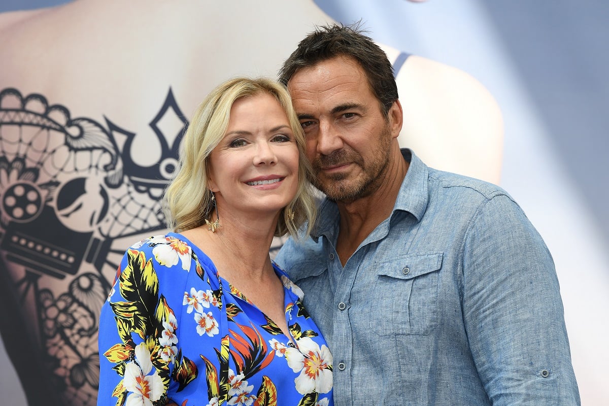 'The Bold and the Beautiful' actor Katherine Kelly Lang in a blue floral dress, and Thorsten Kaye in a blue shirt; share a side hug.
