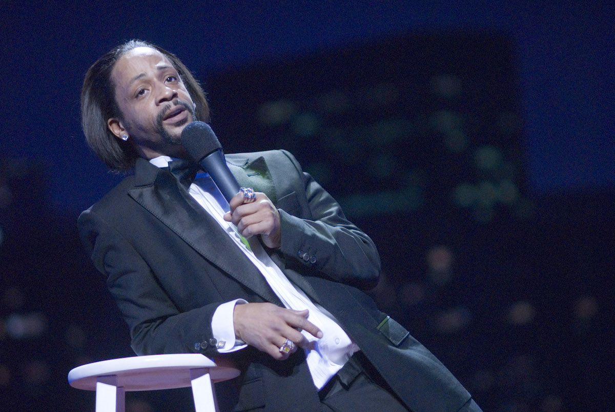 Katt Williams performing on stage, holding a microphone