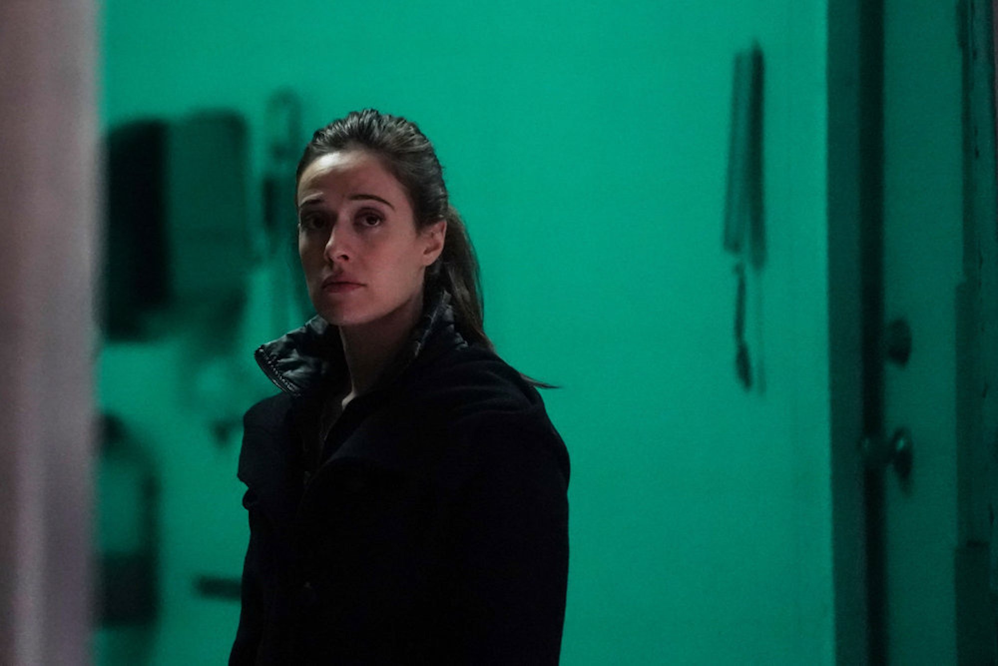 Marina Squerciati as Kim Burgess in the dark against a green background in 'Chicago P.D.' Season 9 Episode 10