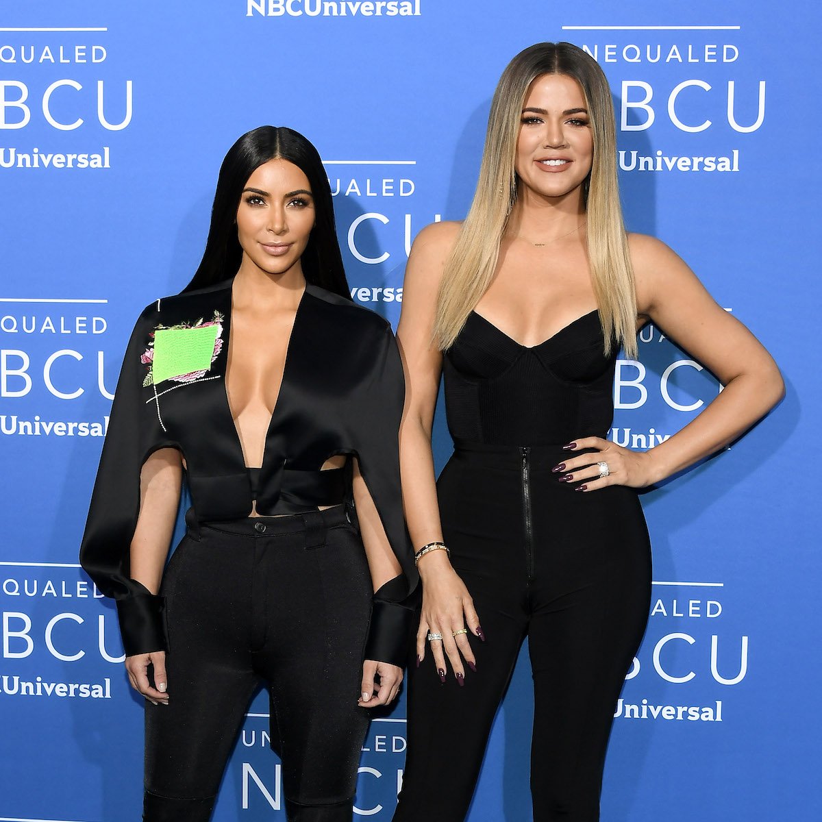Kim Kardashian West and Khloe Kardashian pose together at an event.