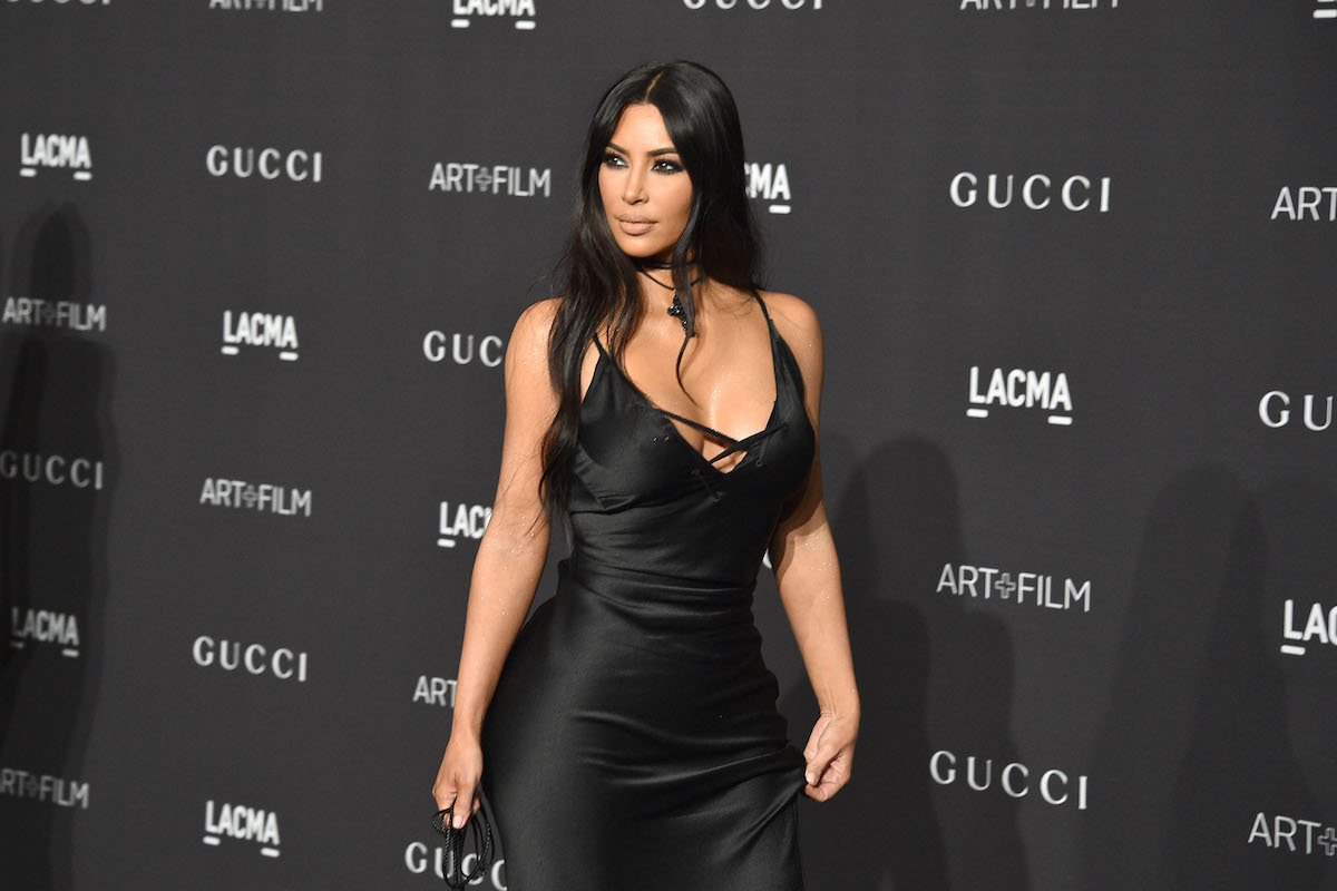 Kim Kardashian West in front of a black background