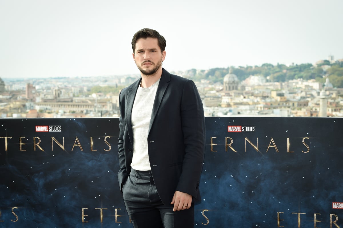 Kit Harington in a white t-shirt, black blazer, and black jacket at a photo call in Rome for Marvel’s Eternals