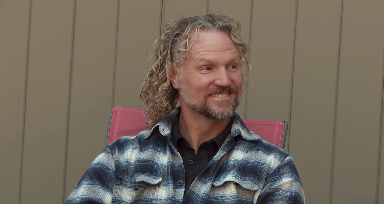 Kody Brown smiling and sitting in a chair on 'Sister Wives.'