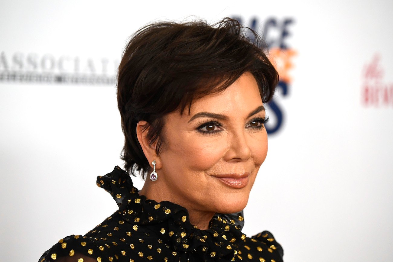 Kris Jenner in front of a white background, close up