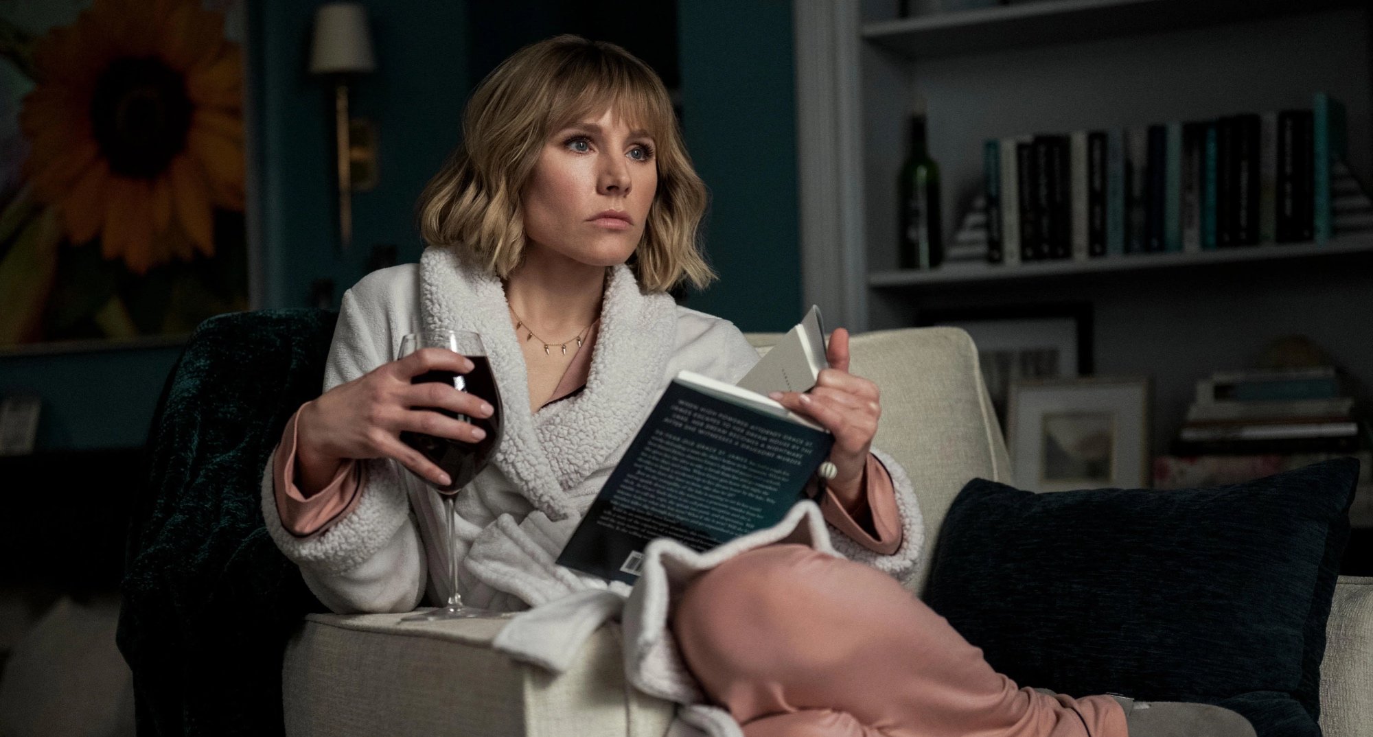 Kristen Bell as Anna in 'The Woman in the House Across the Street from the Girl in the Window' in pajamas drinking wine.