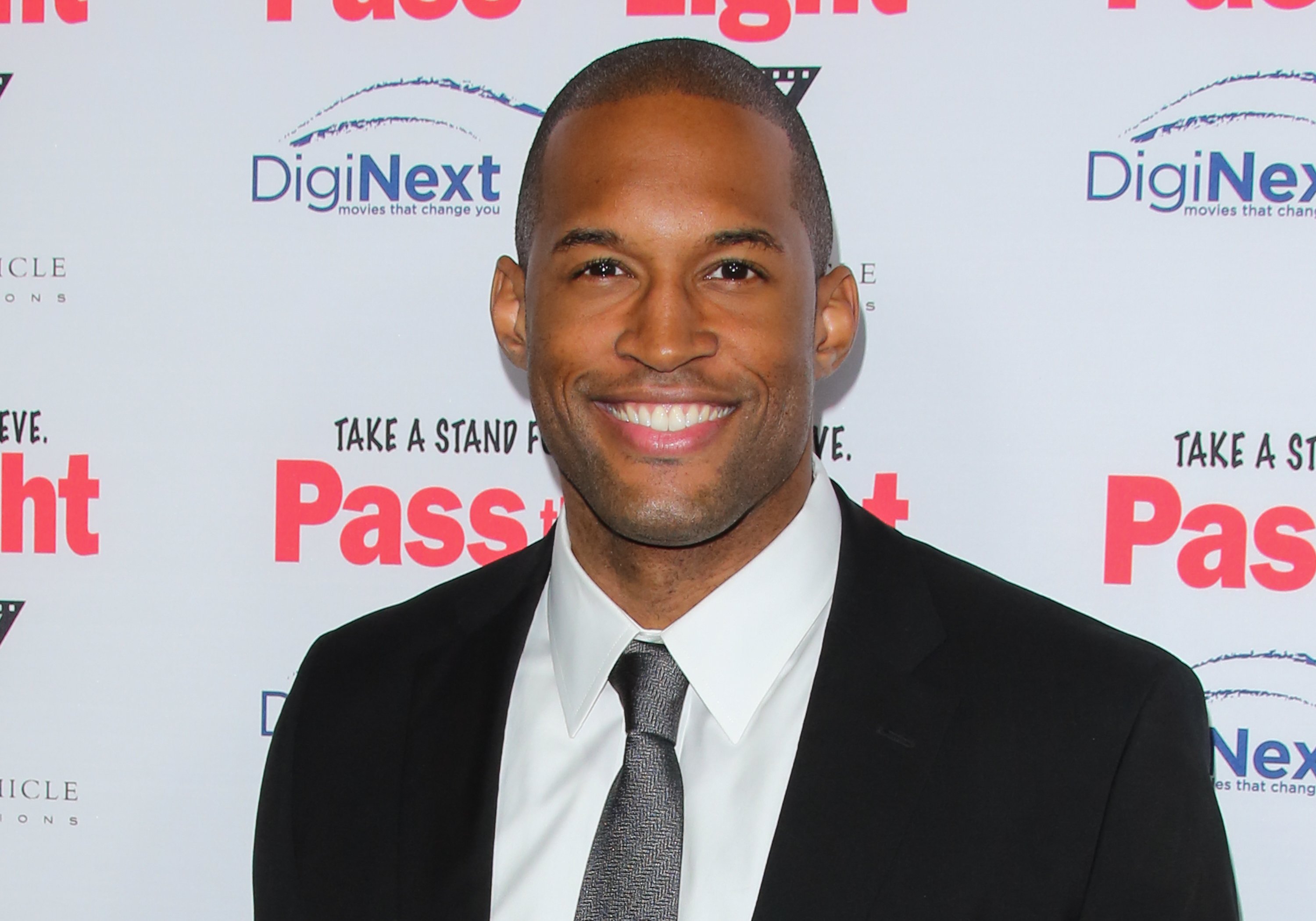 'The Bold and the Beautiful' actor Lawrence Saint-Victor wearing a black suit, tie, and white shirt.