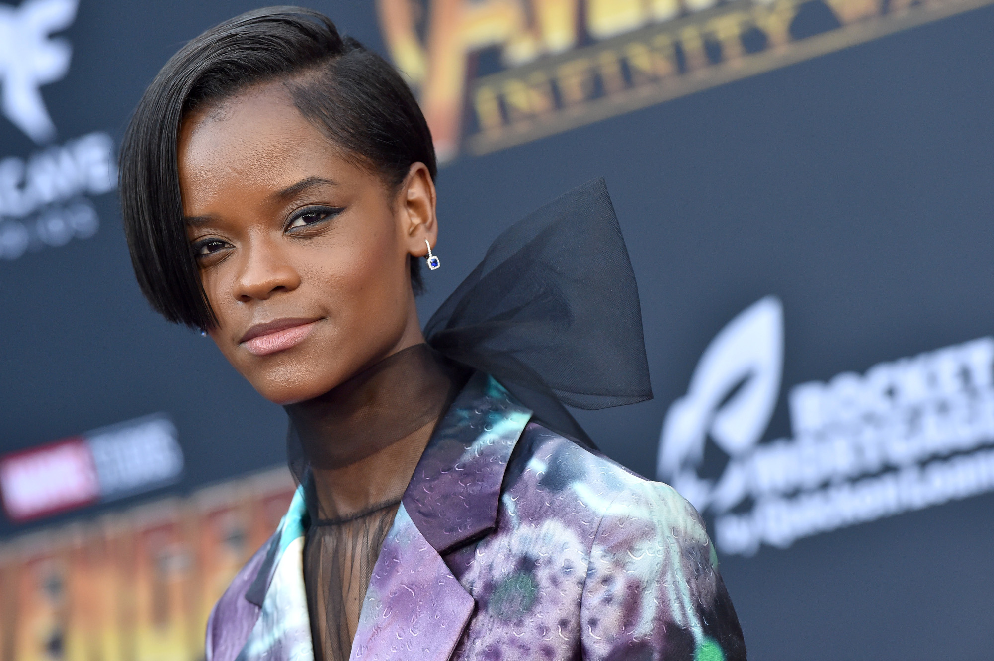 'Black Panther: Wakanda Forever' star Letitia Wright. She's wearing a black, purple, and blue blazer.