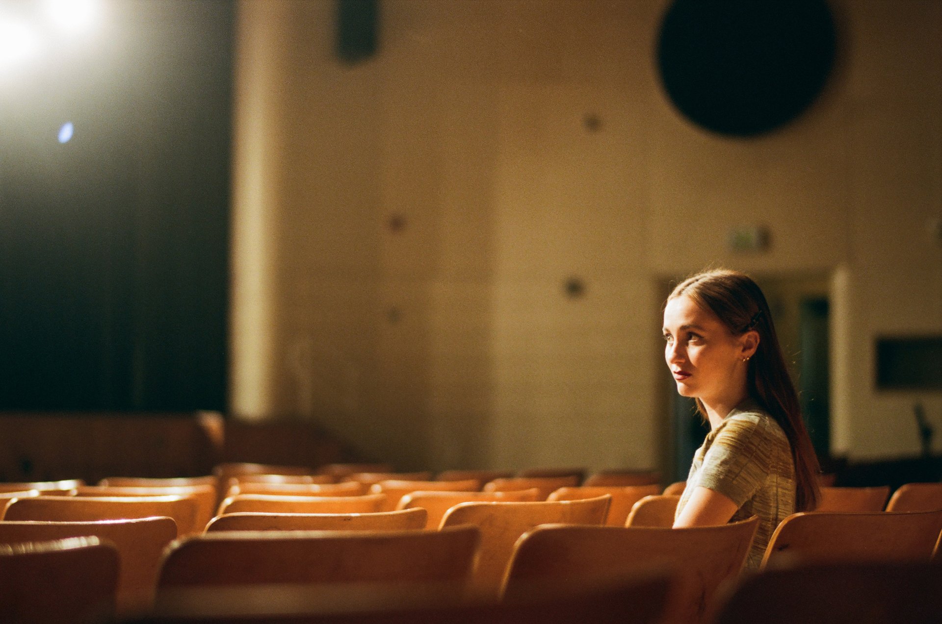 Maude Apatow as Lexi Howard sitting in a theater in the HBO series 'Euphoria'